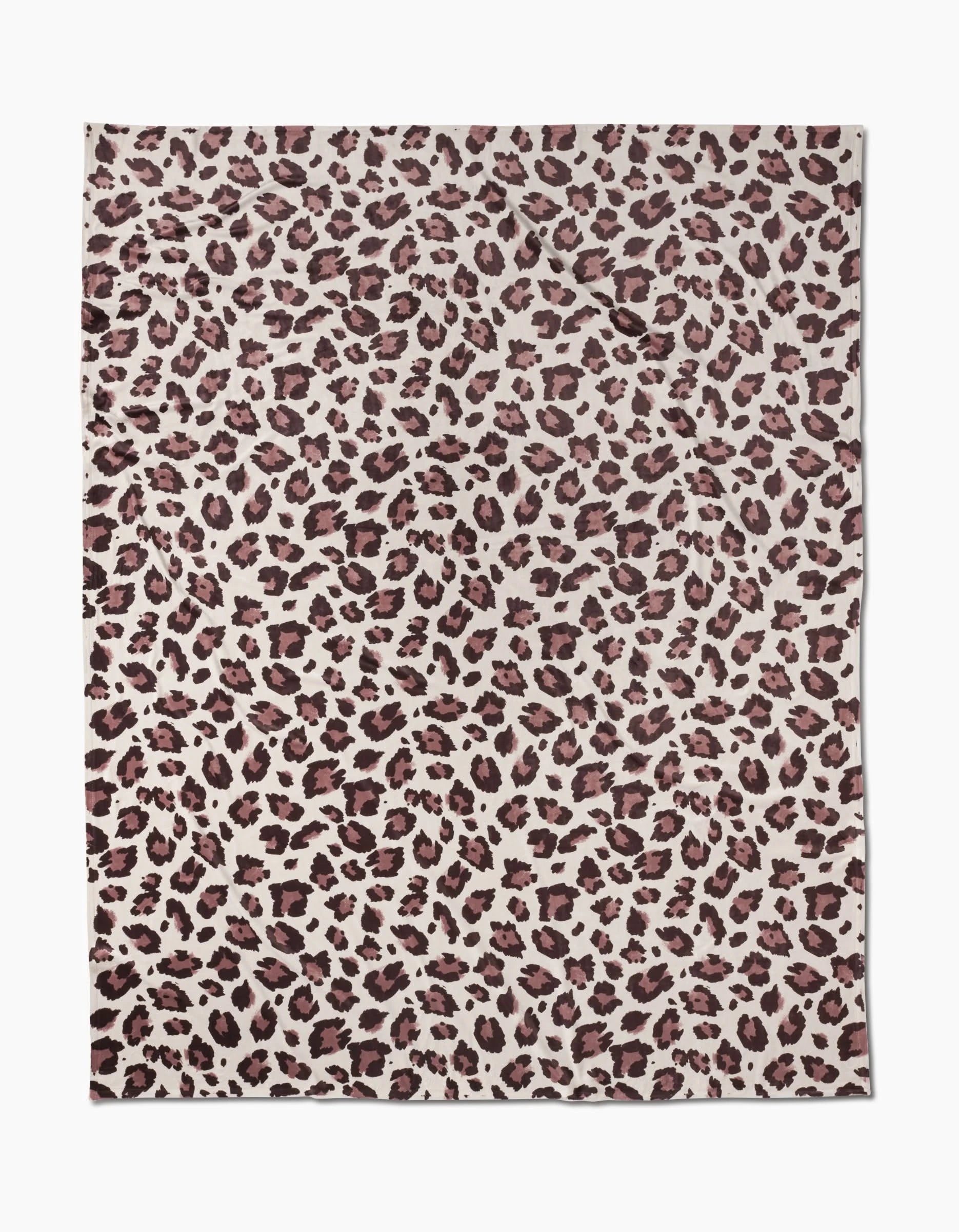 A silky-soft rectangular Geometry Butter Blanket sheet named Cheetah, featuring a cheetah print with dark brown and black spots on a light beige background and a slightly wrinkled appearance.