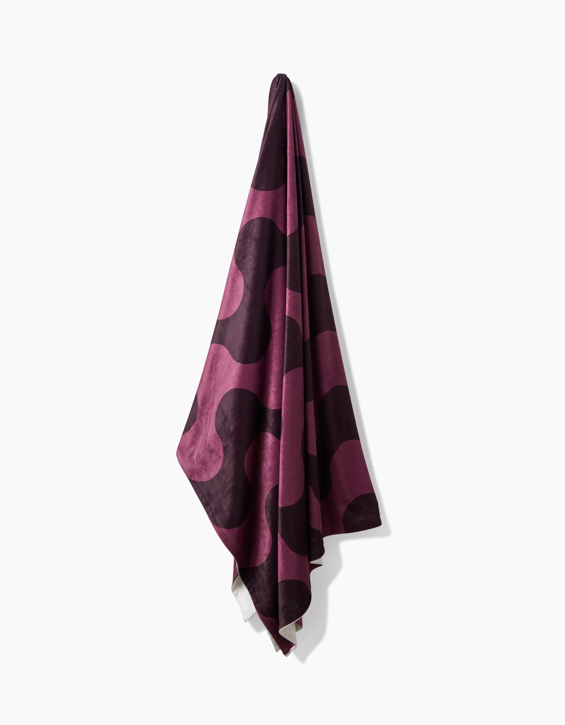 The Geometry Groove With Me towel features a bold, wavy design in dark purple and mauve, hanging against a white background. Made from recycled materials, it offers an eco-friendly touch.