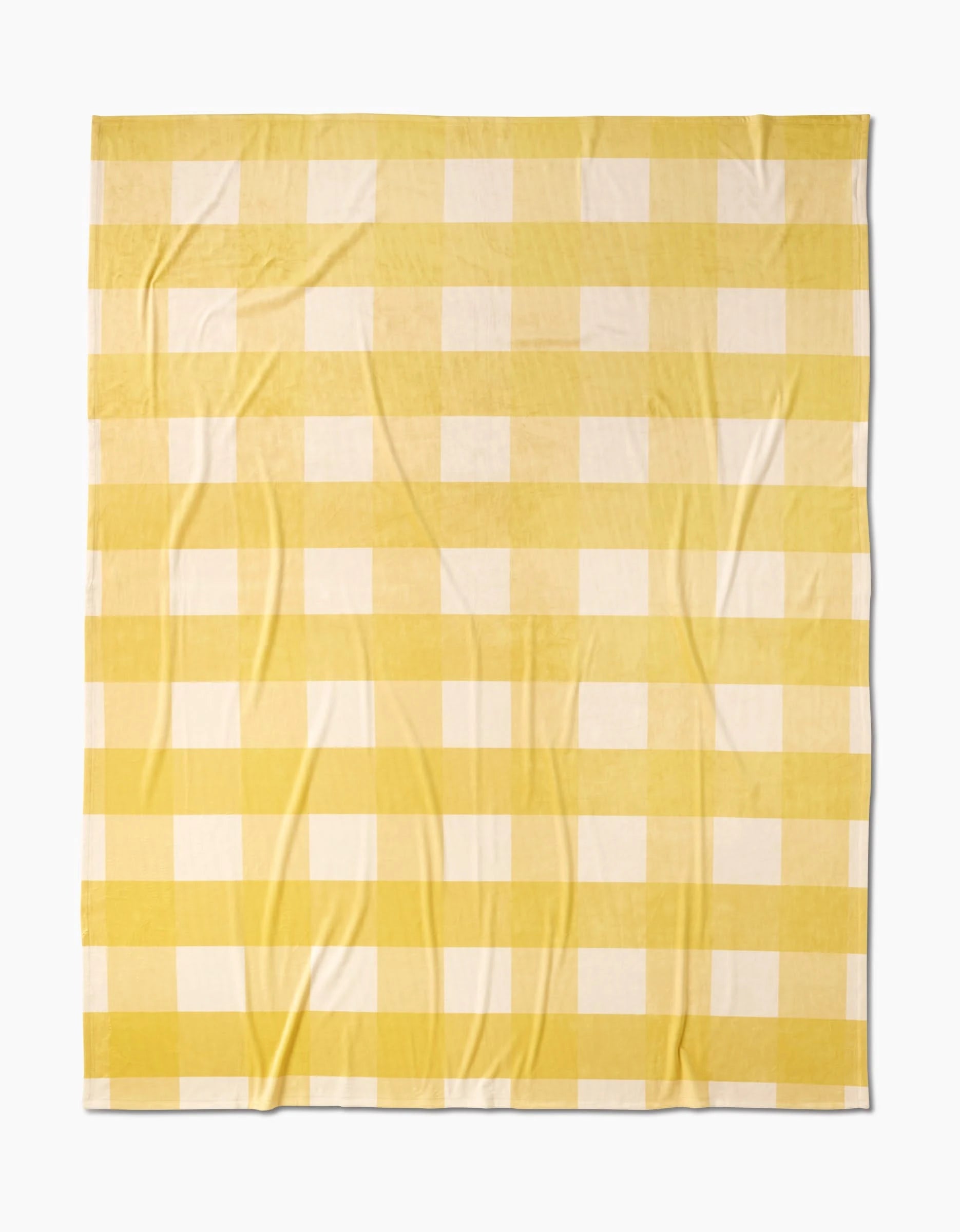 Geometry’s Lemonade Gingham Butter Blanket features a yellow and white checkered pattern with evenly spaced stripes, made from soft, eco-friendly recycled materials.