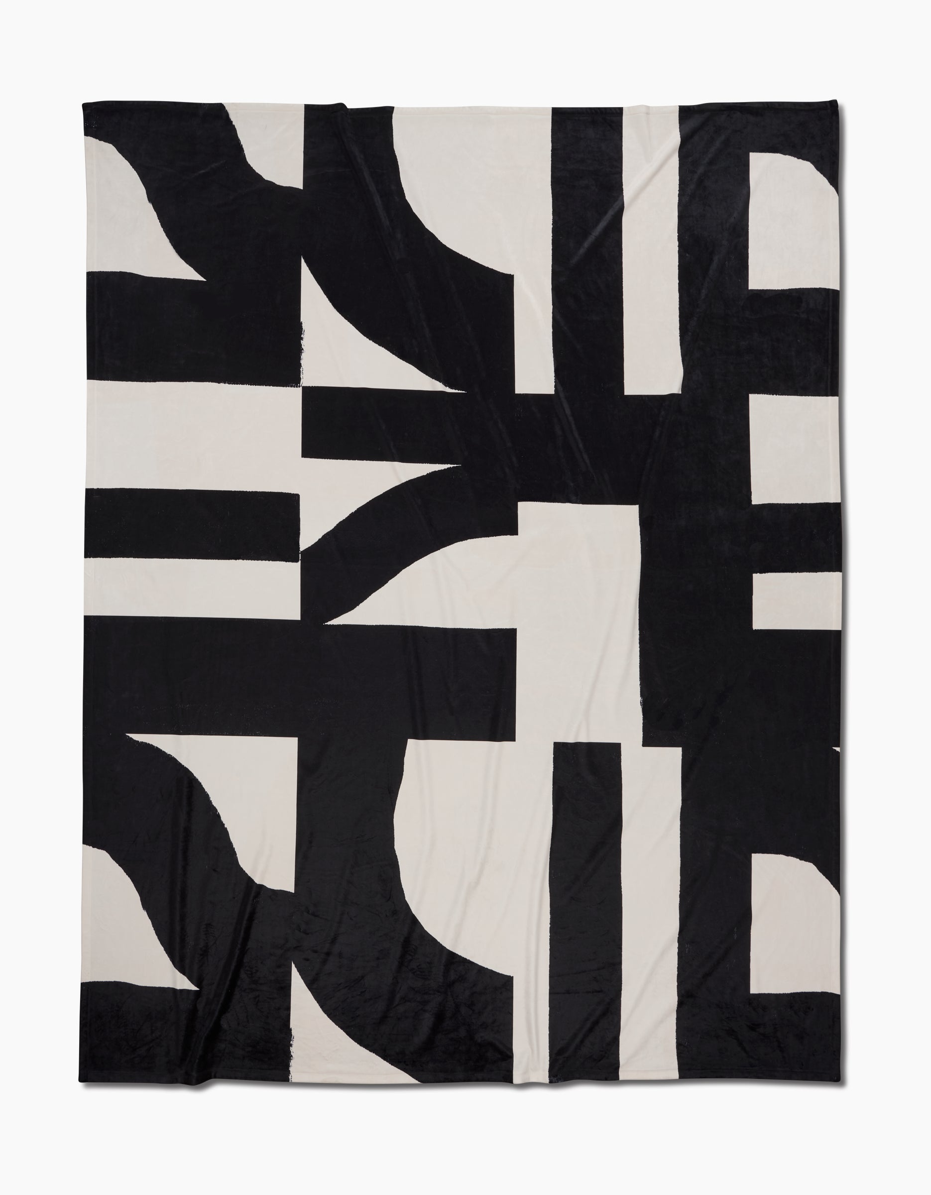 Introducing Lined Square by Geometry: a black and white Butter Blanket with an abstract geometric pattern of bold intersecting shapes and thick lines, crafted for silky softness.