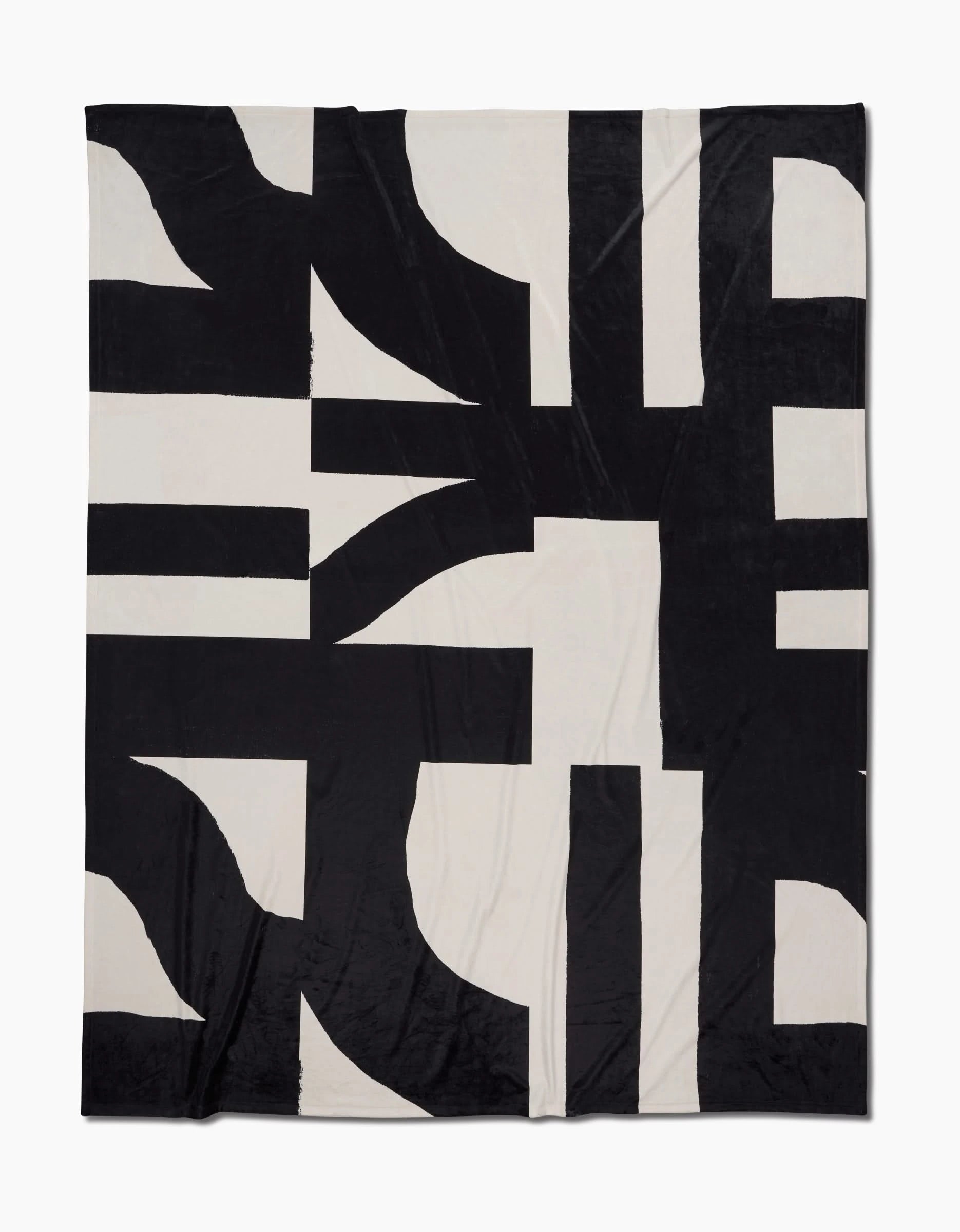Introducing Lined Square by Geometry: a black and white Butter Blanket with an abstract geometric pattern of bold intersecting shapes and thick lines, crafted for silky softness.