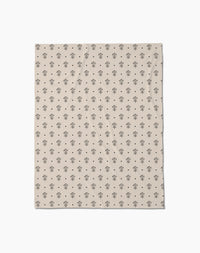 Inked Bloom by Cole Strem is a beige Butter Blanket with a repeating pattern of small, simple black tree illustrations, crafted from eco-friendly recycled materials.