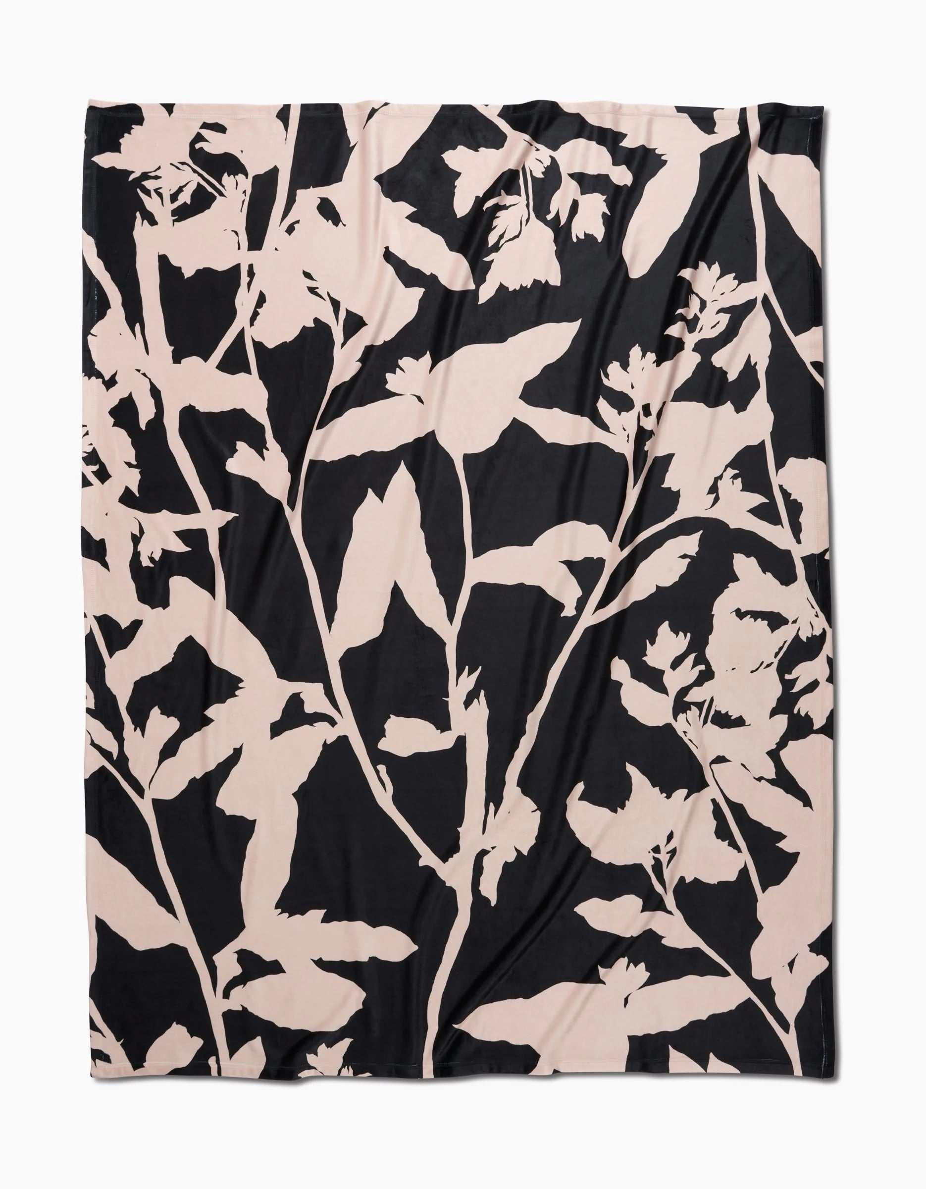 Pam by Geometry is a square fabric made from recycled materials, featuring a bold abstract botanical pattern with large pale beige plant silhouettes on a solid black background for a modern, striking look.