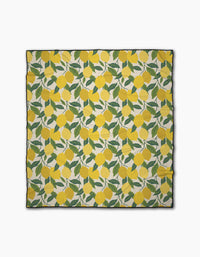 Fresh Start by Susan Heid: a square fabric scarf with a repeating yellow lemon and green leaf pattern on a light background, finished with a thin black border, inspired by the fresh style of Geometry Micro-loop Beach Blanket.
