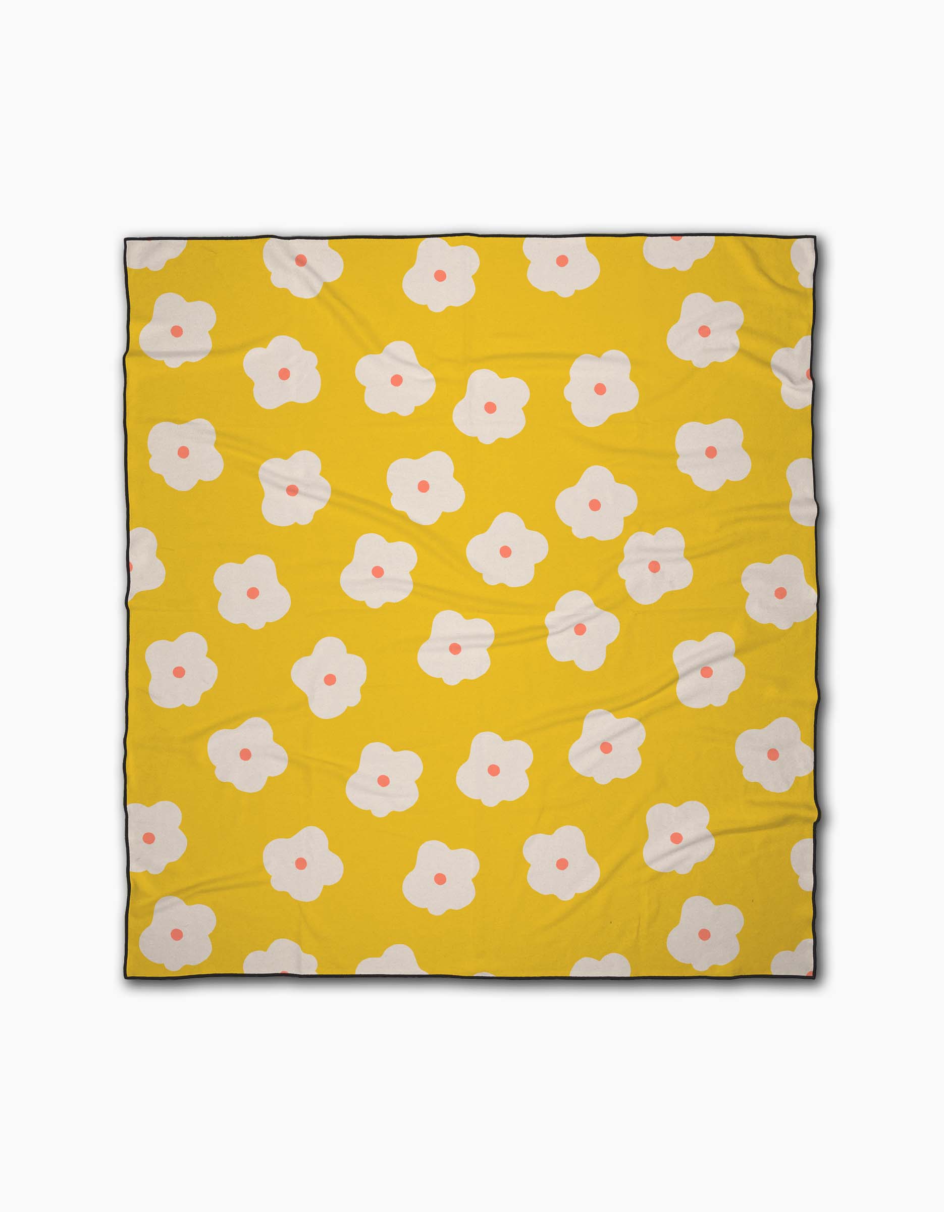 The Sara Mari Garden Crush is a yellow beach blanket patterned with white flower-like shapes featuring pink centers, all evenly spread. Made from quick-drying recycled materials for comfort and sustainability.