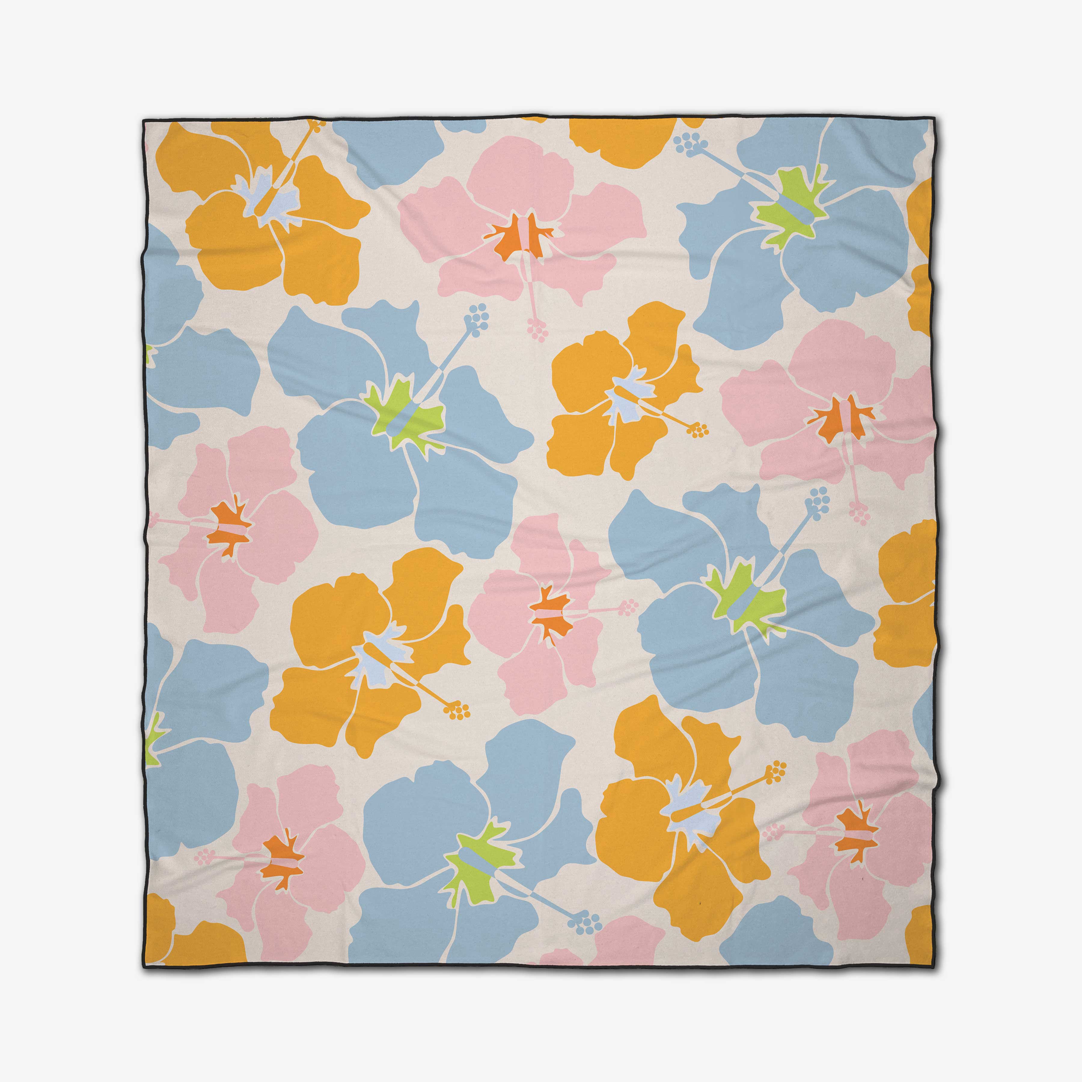 The GEOMETRY Hula Hues beach blanket features large orange, pink, and blue hibiscus flowers with green centers on a light background. Made from quick-drying recycled materials, it has a thin dark border.