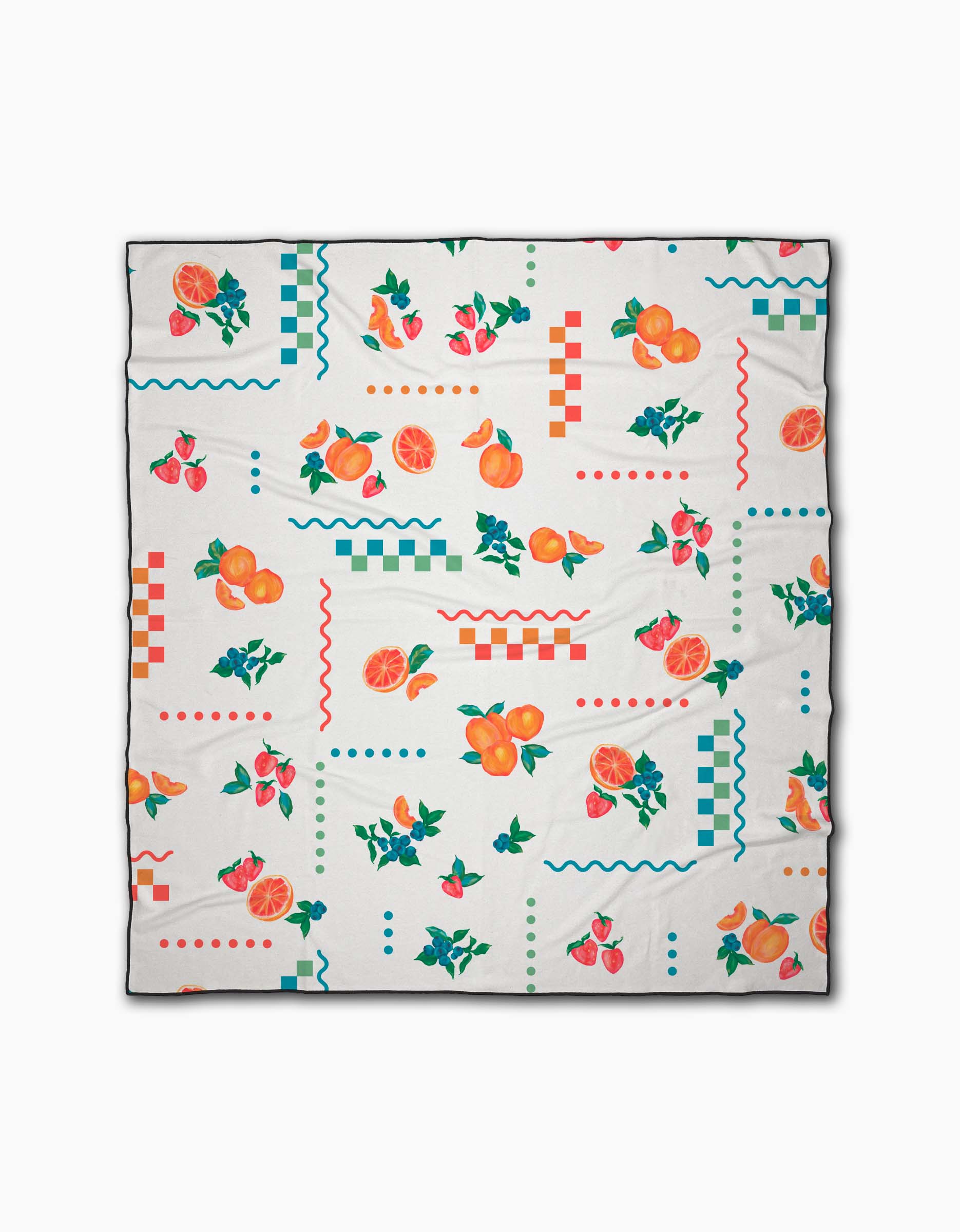 The Sweet Pickings beach blanket by Aubrey Fairchild is white with vibrant orange, strawberry, and geometric prints in red, green, blue, and orange. Made from quick-drying recycled materials.