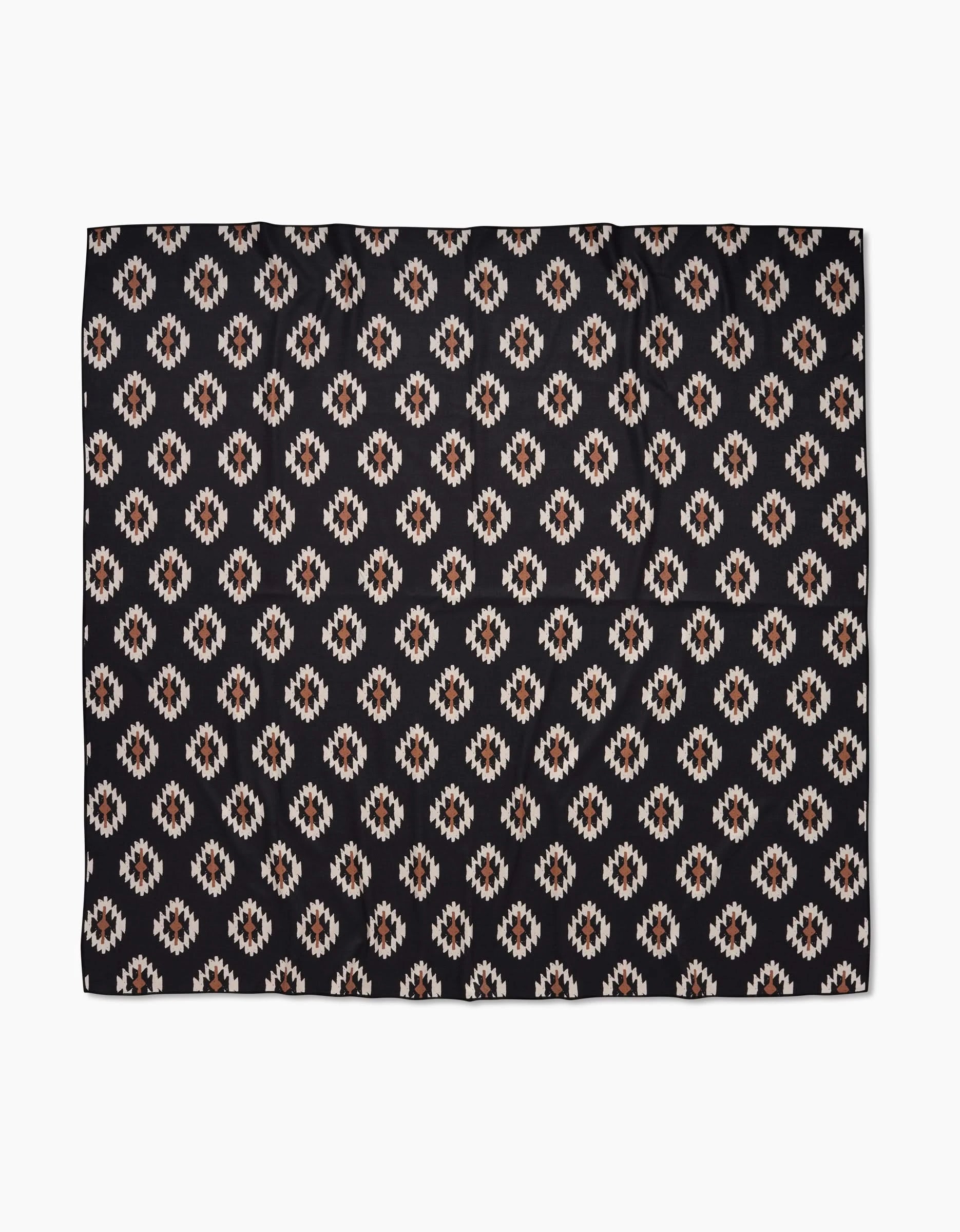 The Hufton Studio Western Tile Beach Blanket showcases a repeating geometric pattern with diamond motifs in white, tan, and brown on black, crafted from quick-drying recycled materials.