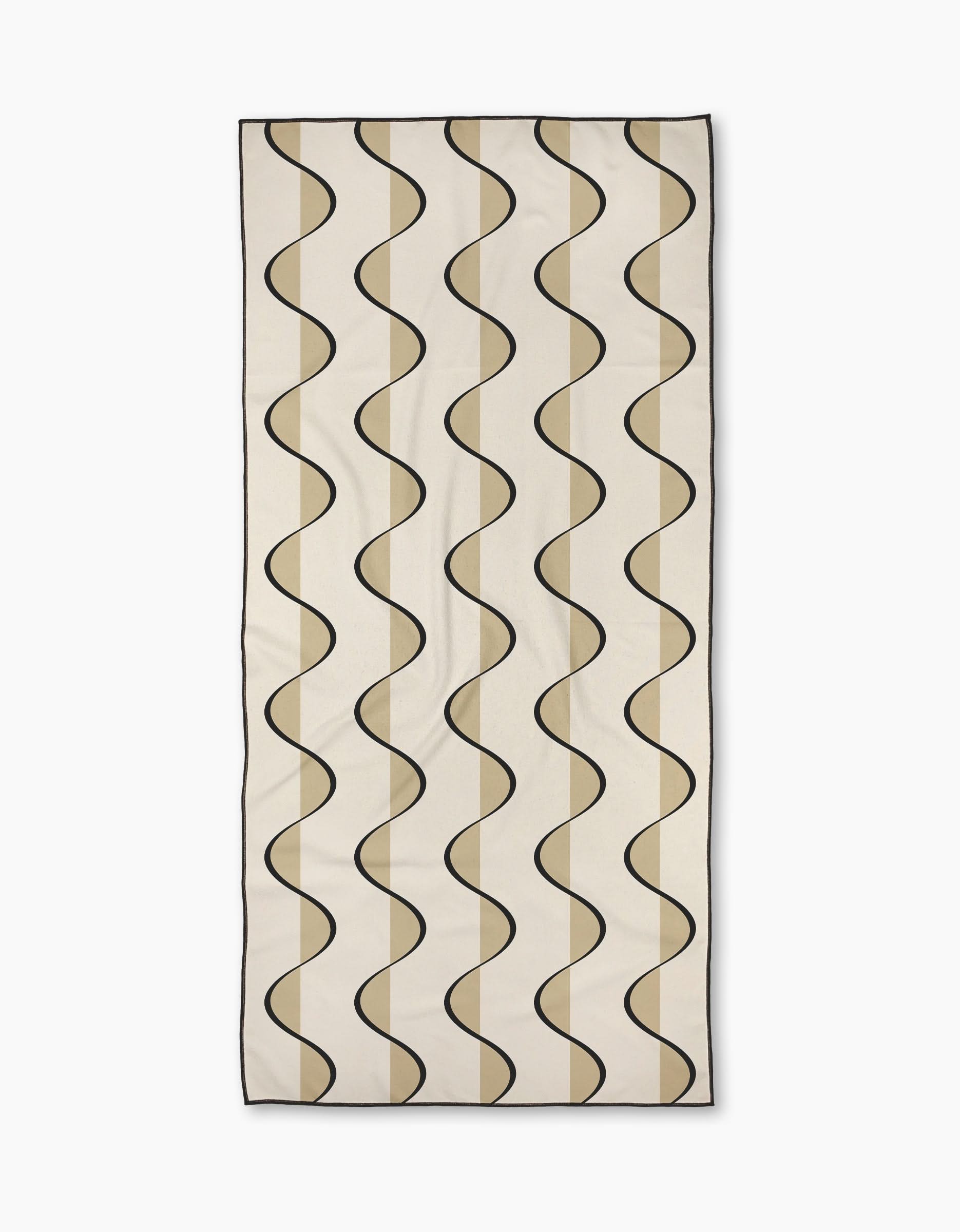 Desert Drift by Geometry: a rectangular beige, ultra-absorbent towel with evenly spaced wavy black lines and tan shapes in a repeating pattern.