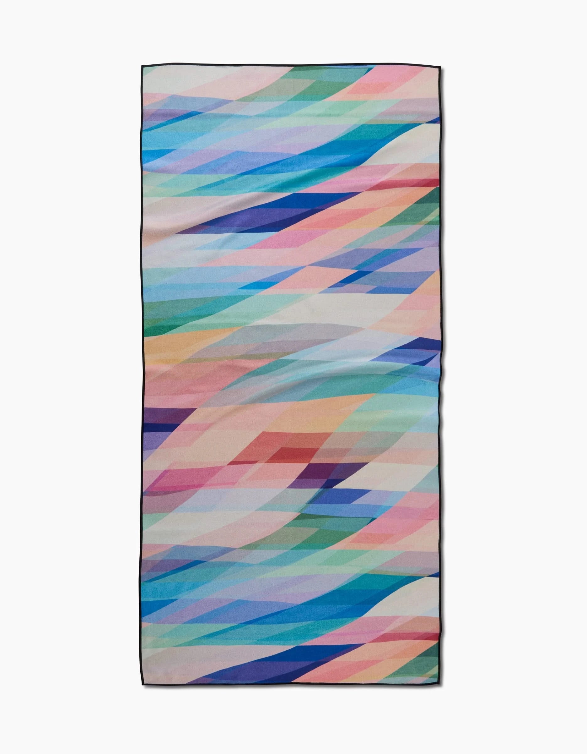 The Eventide Micro-loop Beach Towel by Rachel Parker features multicolored geometric diagonal shapes on white. Made with recycled materials, it offers a quick-drying, eco-friendly beach experience.