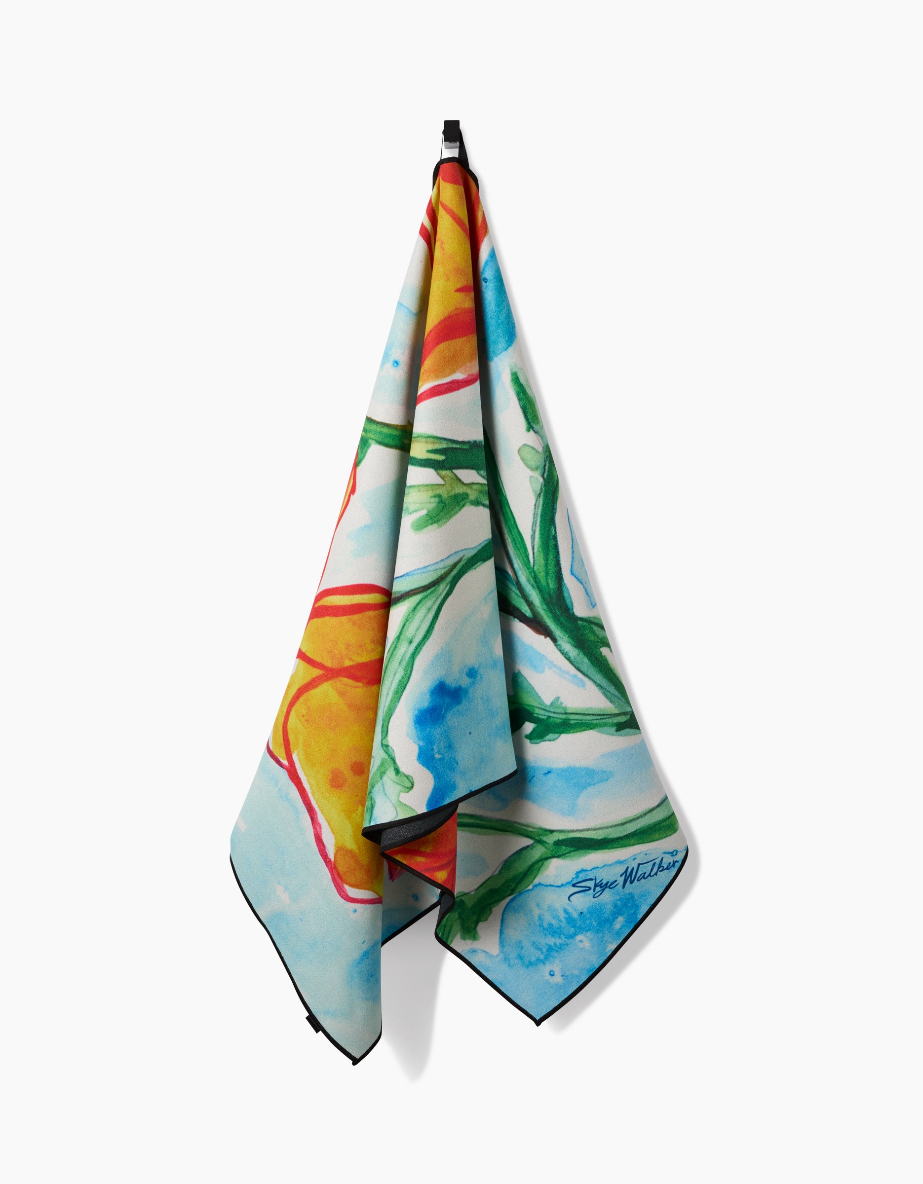 A vibrant Golden Poppy Flowers Micro-loop Beach Towel by Skye Walker, featuring an abstract floral design in blue, green, orange, and yellow tones, hangs from a hook. The quick-drying fabric is signed by the artist.