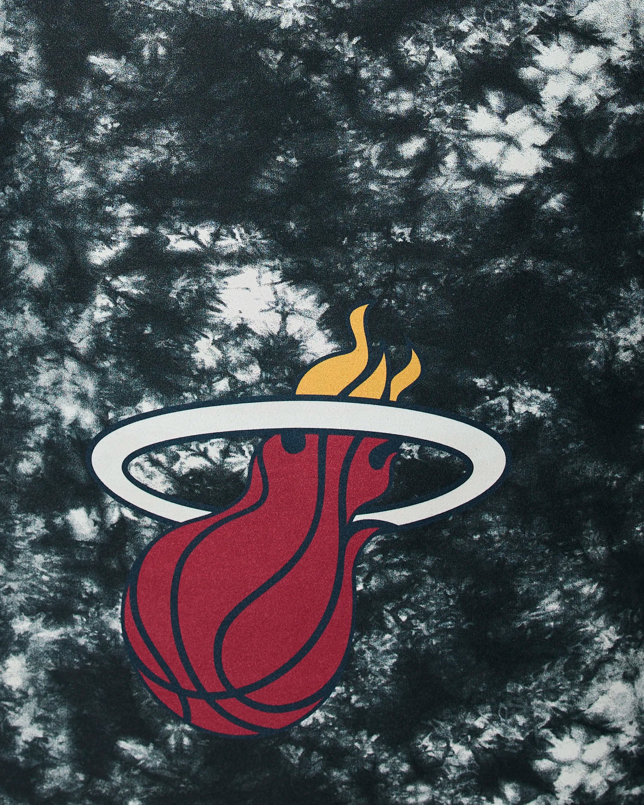 The Heat Flash by Geometry features a red basketball with flames passing through a white ring on a black and white tie-dye background, inspired by the Miami Heat basketball team logo.