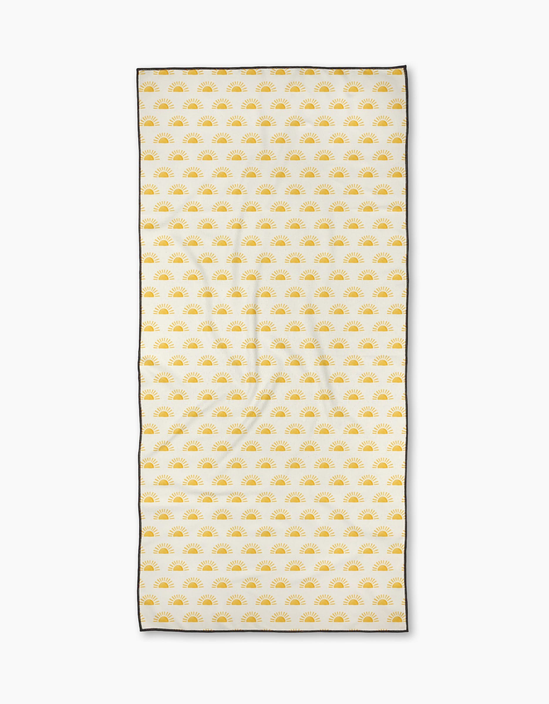 The Here Comes The Sun beach towel by Aubrey Fairchild is rectangular, white, quick-drying, and features a pattern of small yellow suns with a thin black border. It is shown laid flat on a white background.