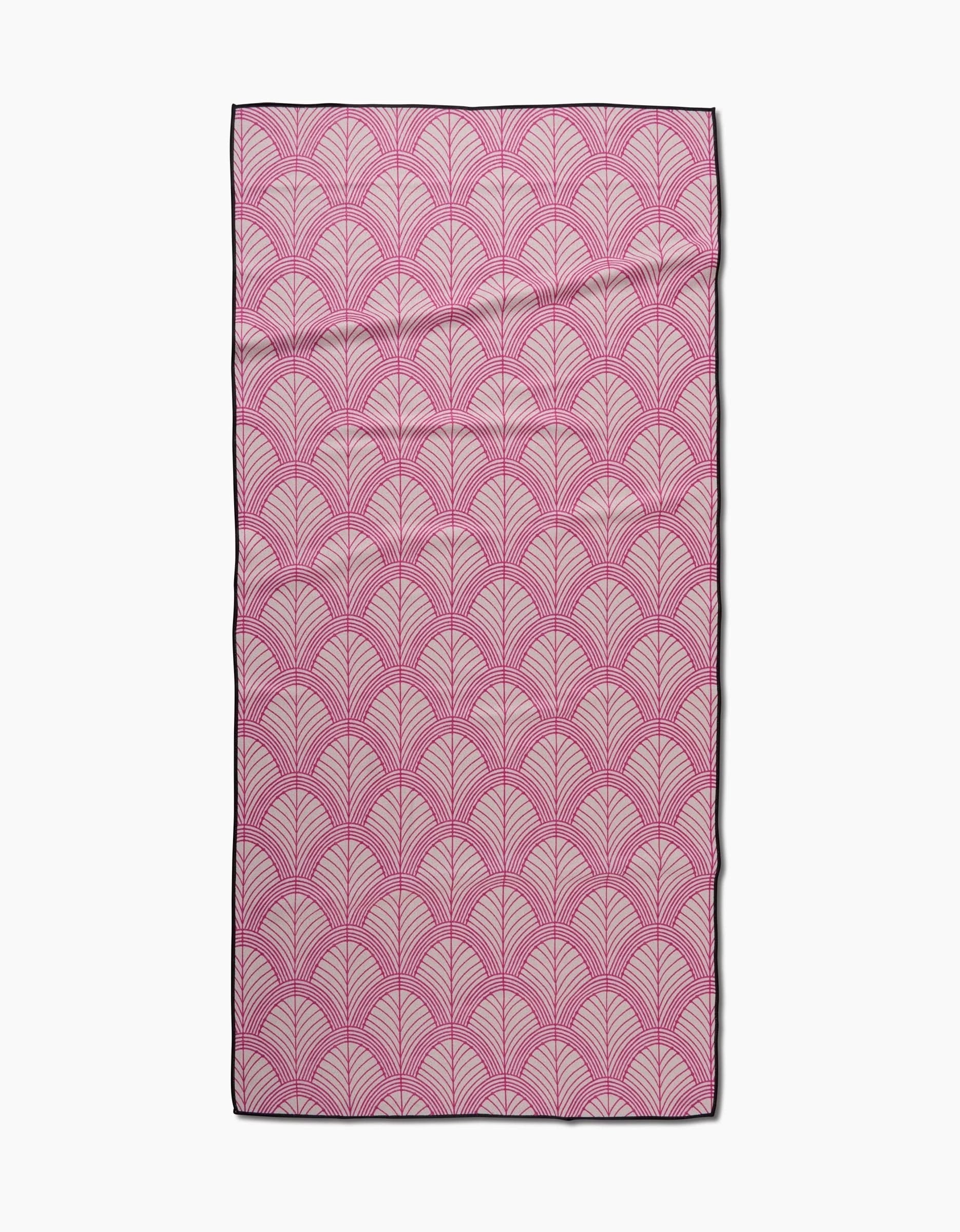 The Amy MacCready Jaskin rectangular beach towel, made from quick-drying recycled materials for style and sustainability, features a pink and white scallop pattern with a dark border, displayed flat on a white background.