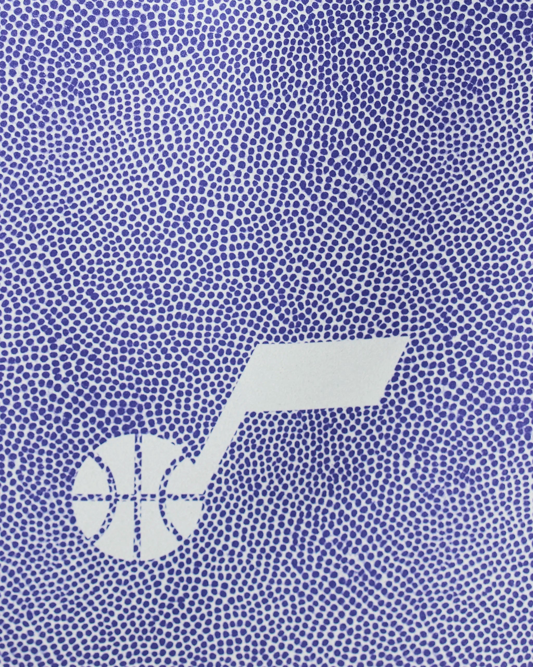 The Geometry Jazz Grip features a stylized white basketball and musical note logo set against a blue, pebble-textured background.
