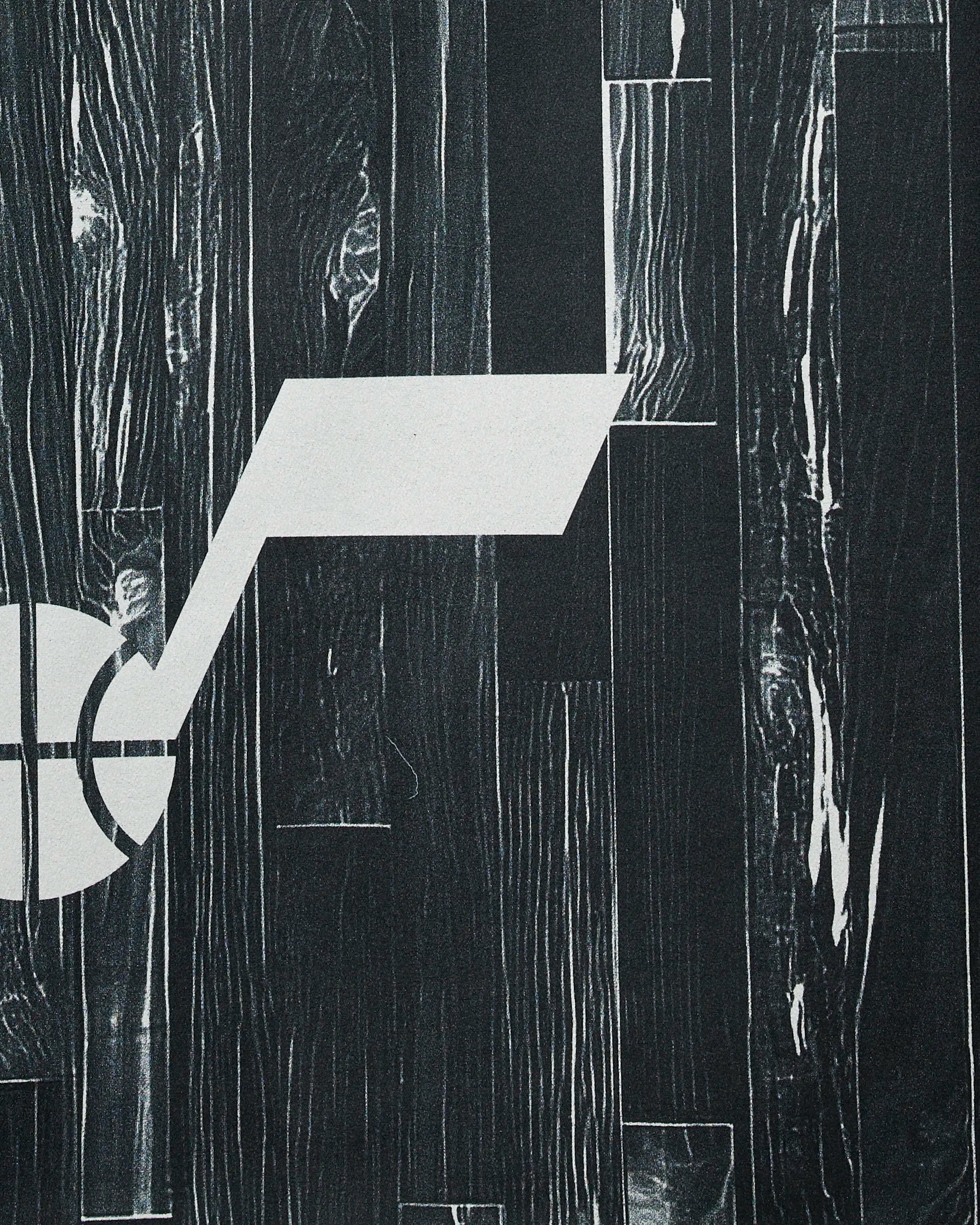 A minimalist white abstract shape, like a check mark crossing a partial circle, stands out on a dark wood-textured background—reflecting the modern style of the Jazz Zone towel by Geometry.