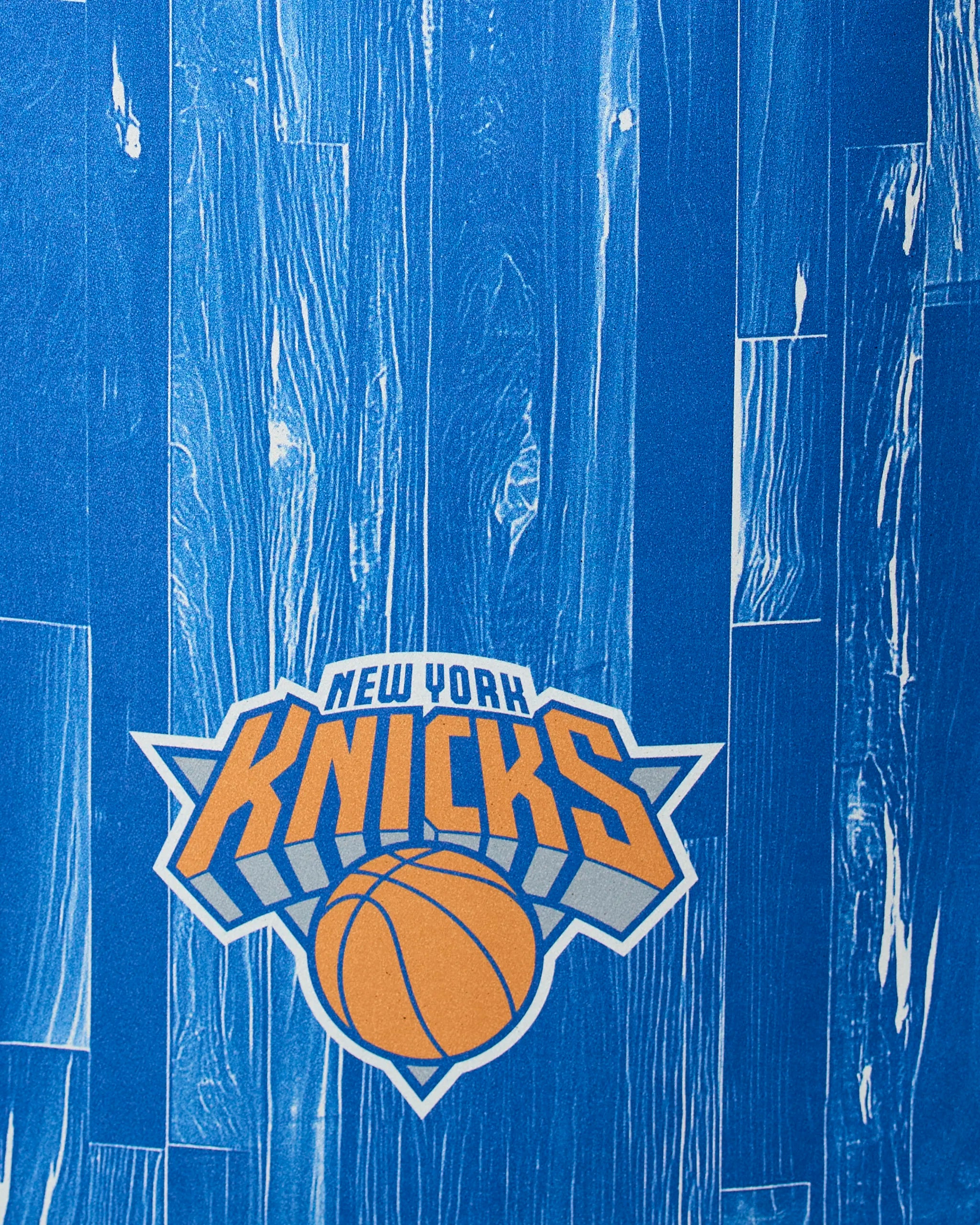 The image displays Geometry’s Knicks Zone, featuring an orange basketball and bold orange text with a blue outline on a blue wood-grain patterned background.