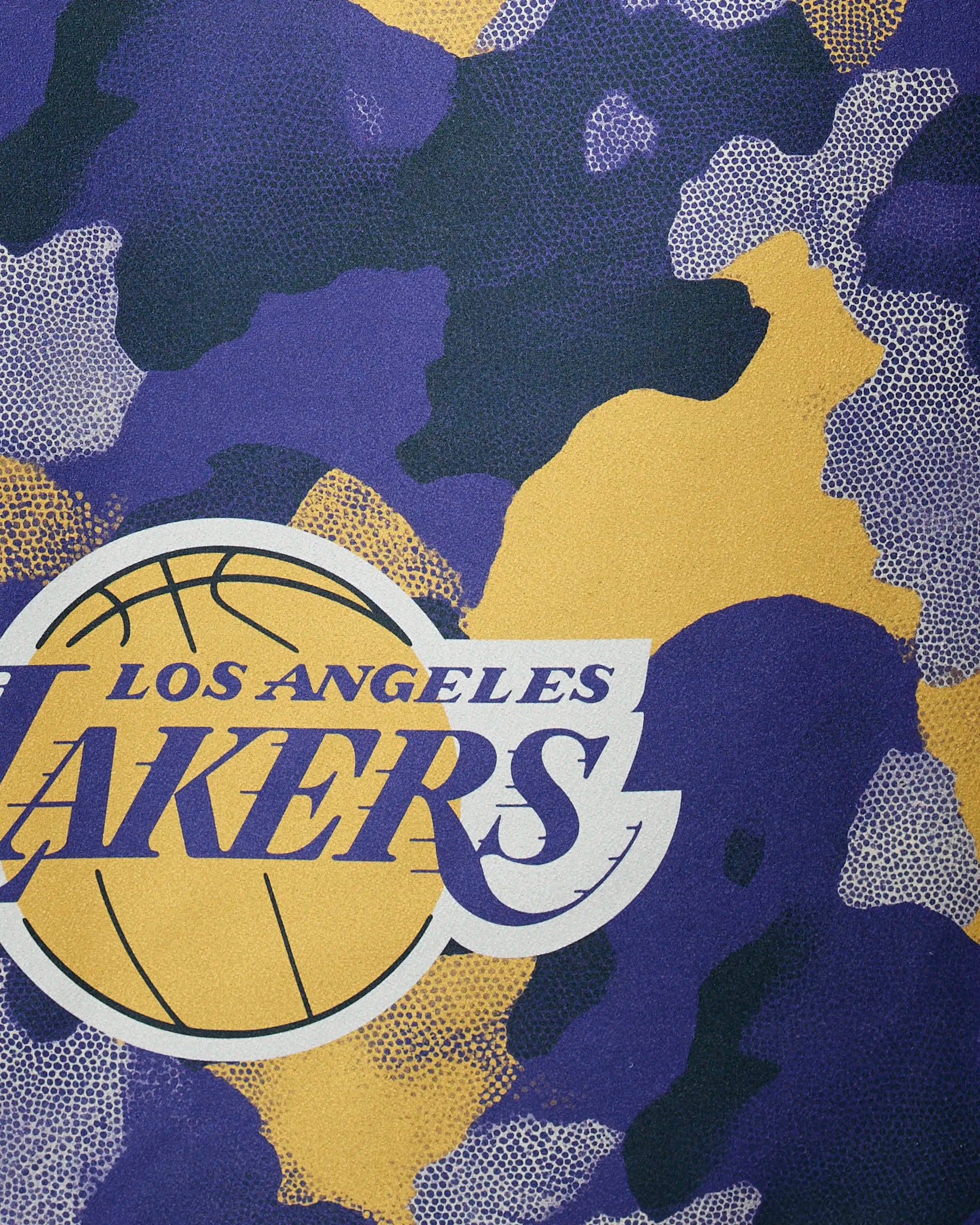 The Geometry Lakers Camo quick-drying beach towel features the Los Angeles Lakers logo with a basketball and text, displayed on a purple, gold, and black camouflage-patterned background.