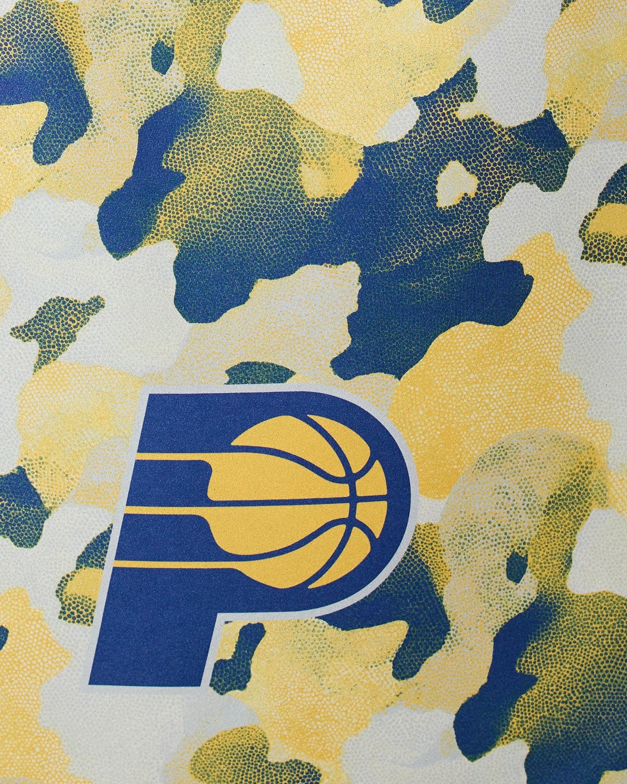 The Geometry Pacers Camo features a blue and yellow Indiana Pacers basketball logo set against a textured background with a camouflage pattern in yellow, blue, and white.