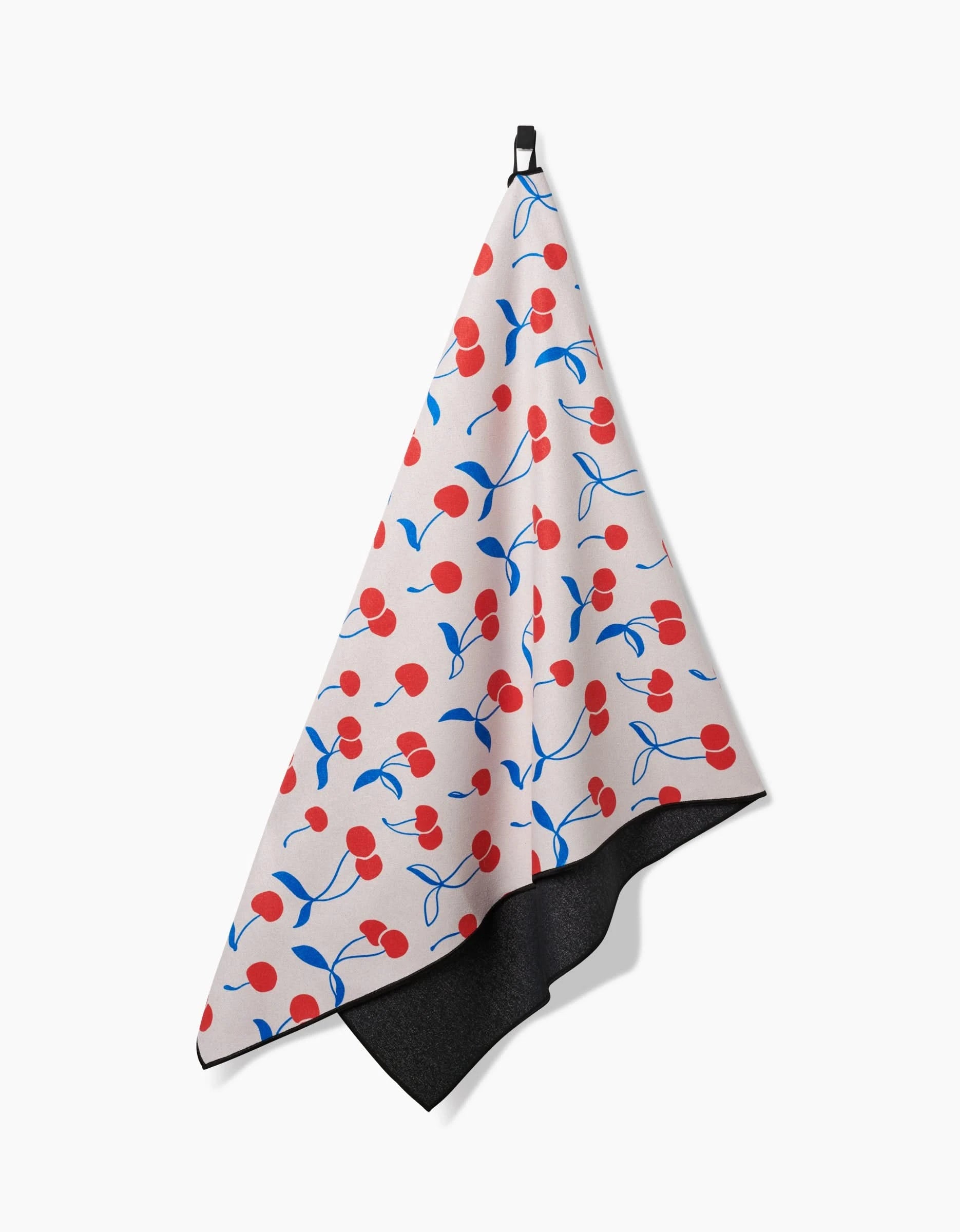 The Kayla Ann Very Cherry towel features a playful red cherries pattern with blue stems on a white background, hangs by a black loop, is made from recycled materials, and has a solid black underside for added style.