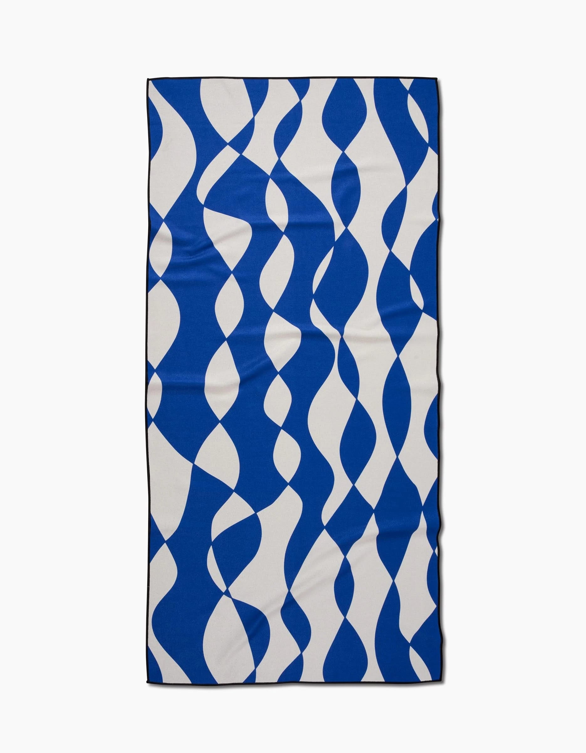 The Wonky Lines beach towel by Claire Iglesias features a bold blue and white abstract wavy pattern. Made from quick-drying, recycled materials, it offers eco-friendly comfort in a rectangular micro-loop design.