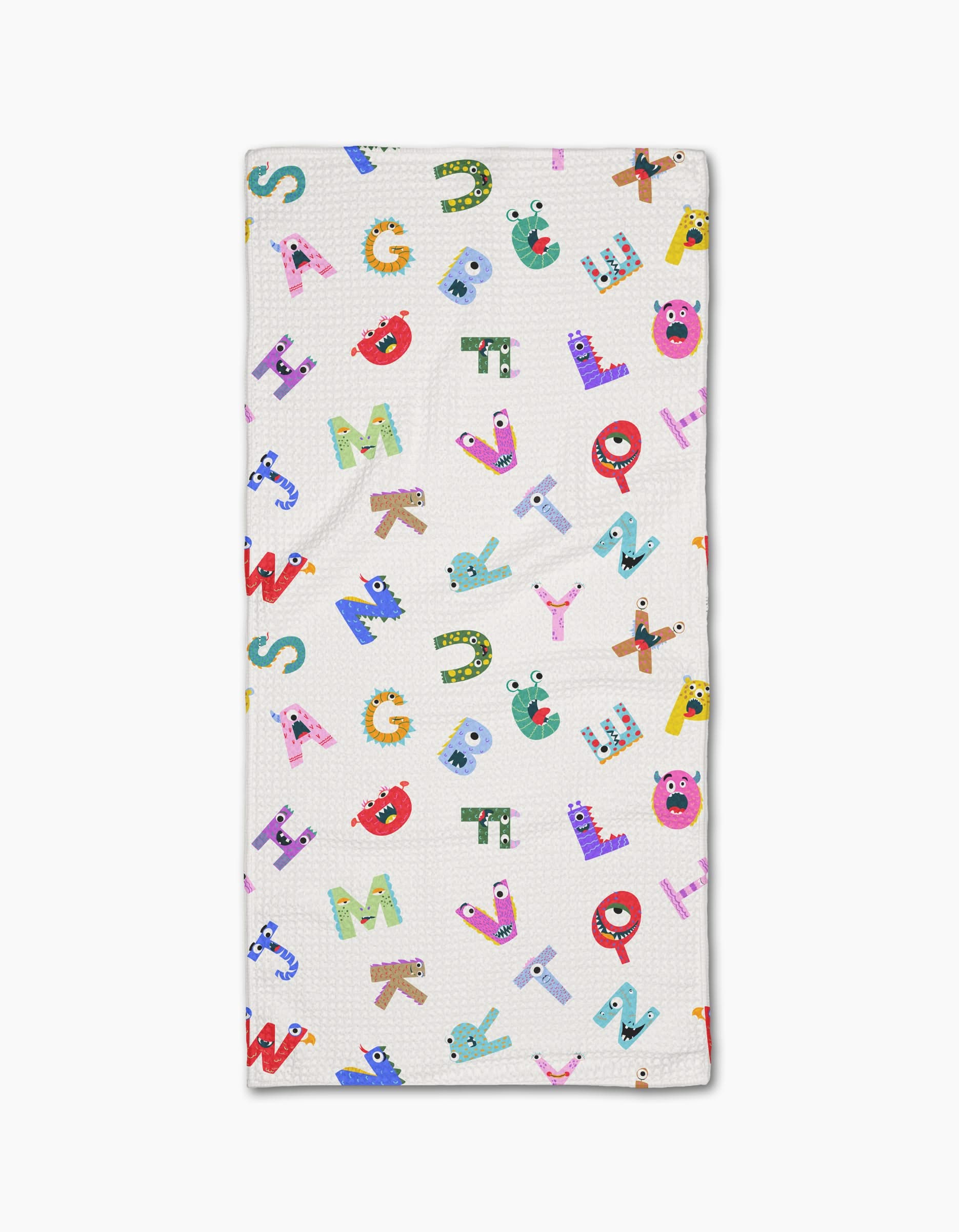 The Vaishali Design Studio Alphabet Monsters baby blanket is white, made from recycled materials, and features colorful letters with playful cartoon monster faces and details.
