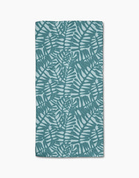 The Aqua Modern Palm towel by Katie OShea is rectangular and ultra-absorbent, showcasing a teal palm leaf pattern on a light blue background with overlapping tropical leaves in a repeating design.
