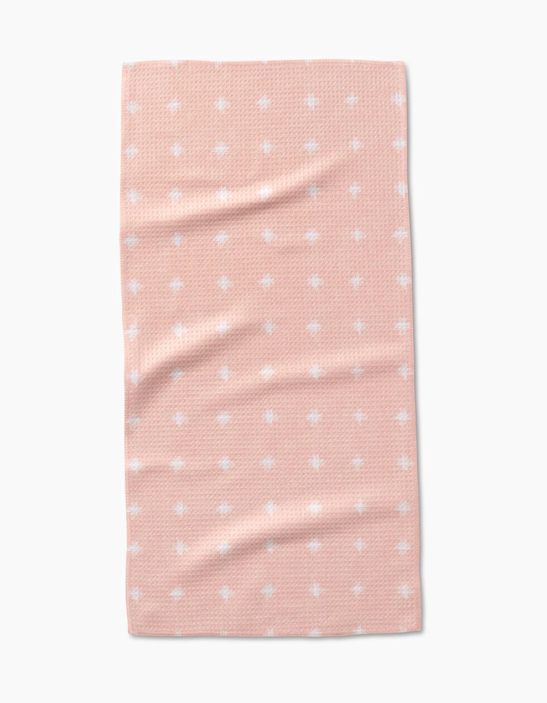 The Amy MacCready Aveline towel is a rectangular, peach-colored bar towel made from ultra-absorbent Geoweave fabric with a textured pattern and evenly spaced small white dots, displayed on a plain white background.