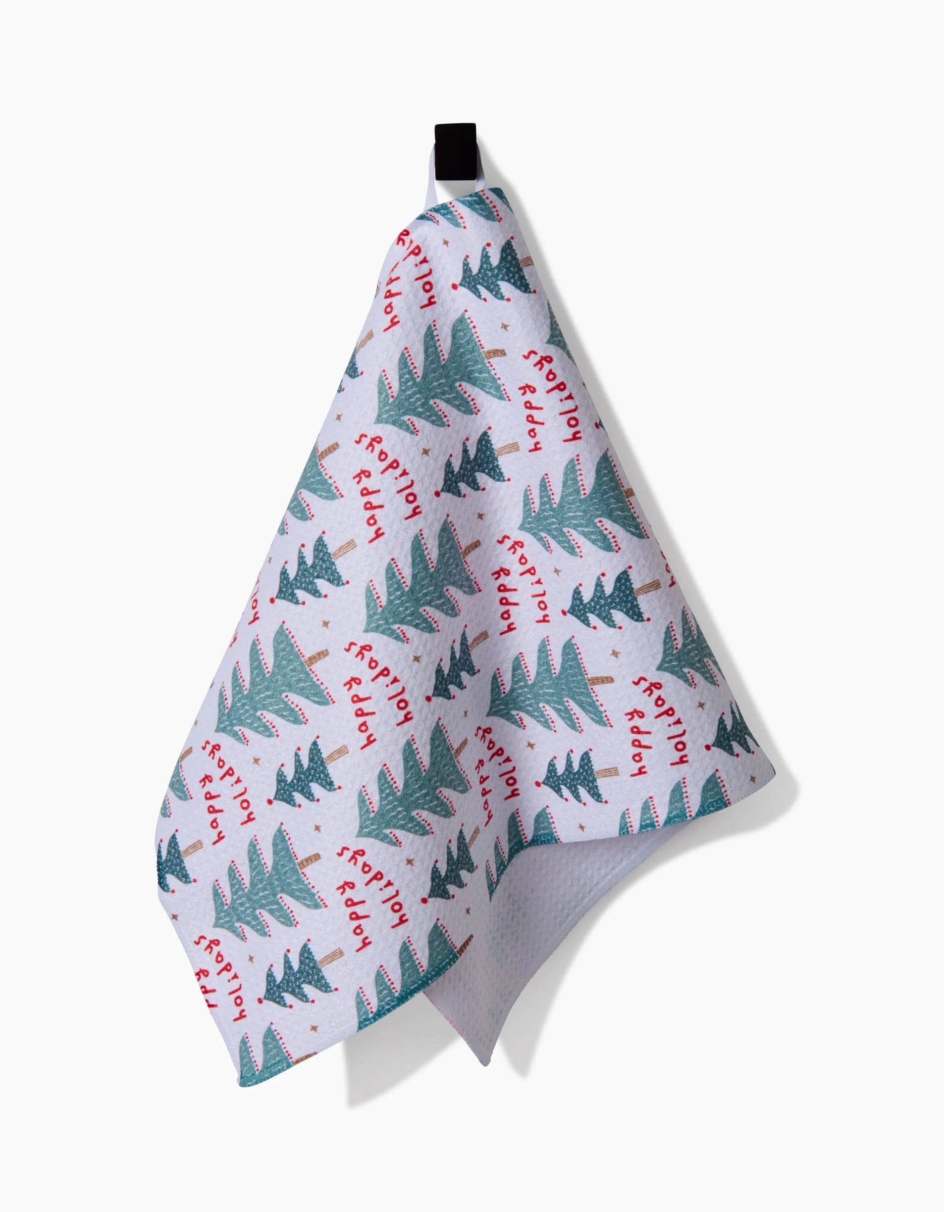 The Berry Happy Holidays bar towel by Roxy Marj, made from recycled materials, features green Christmas trees and red frosty field text. It hangs from a black loop against a white background.