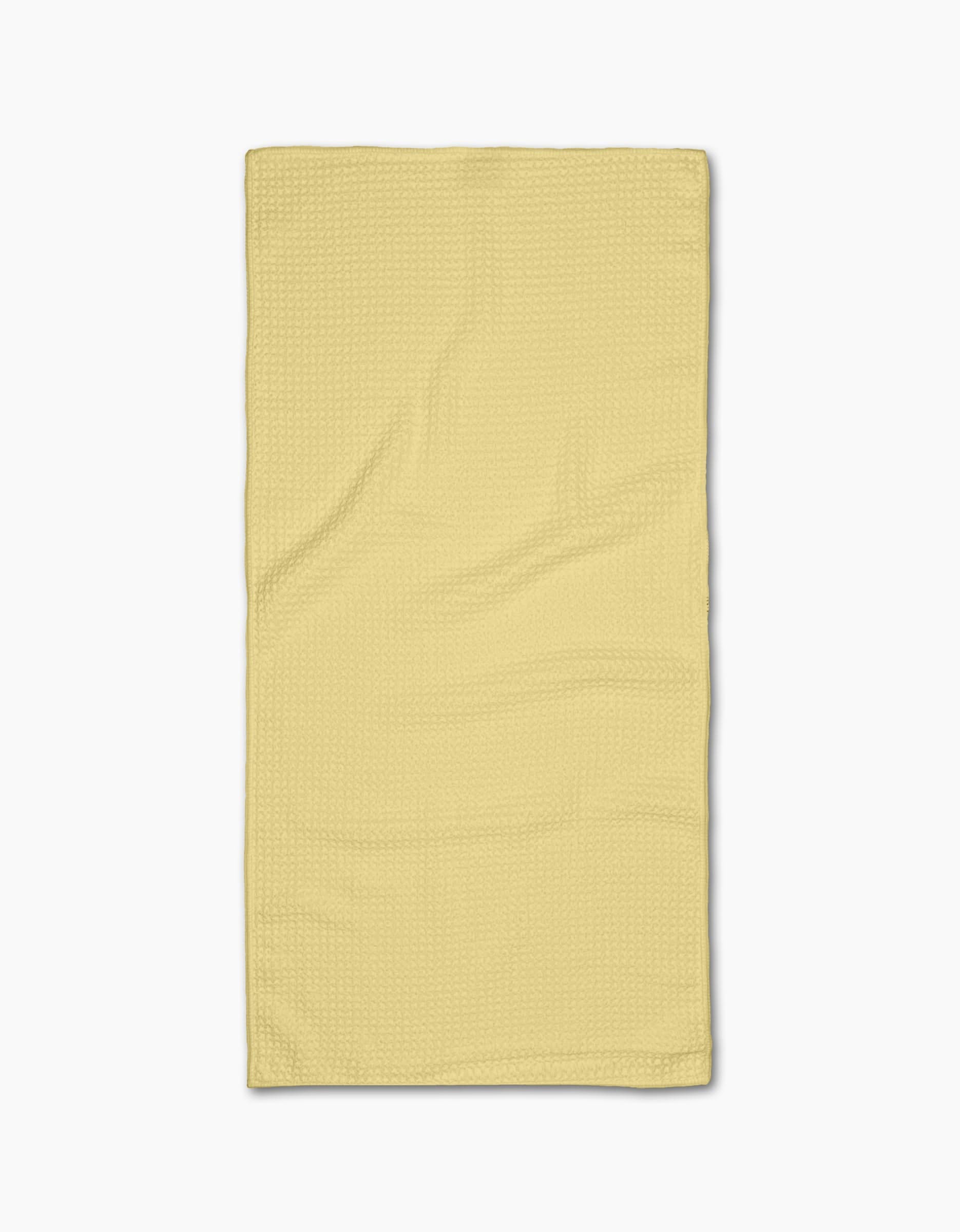 A neatly laid flat, Butter Yellow rectangular Bar Towel from GEOMETRY with a subtle textured Geoweave pattern, photographed on a plain white background.