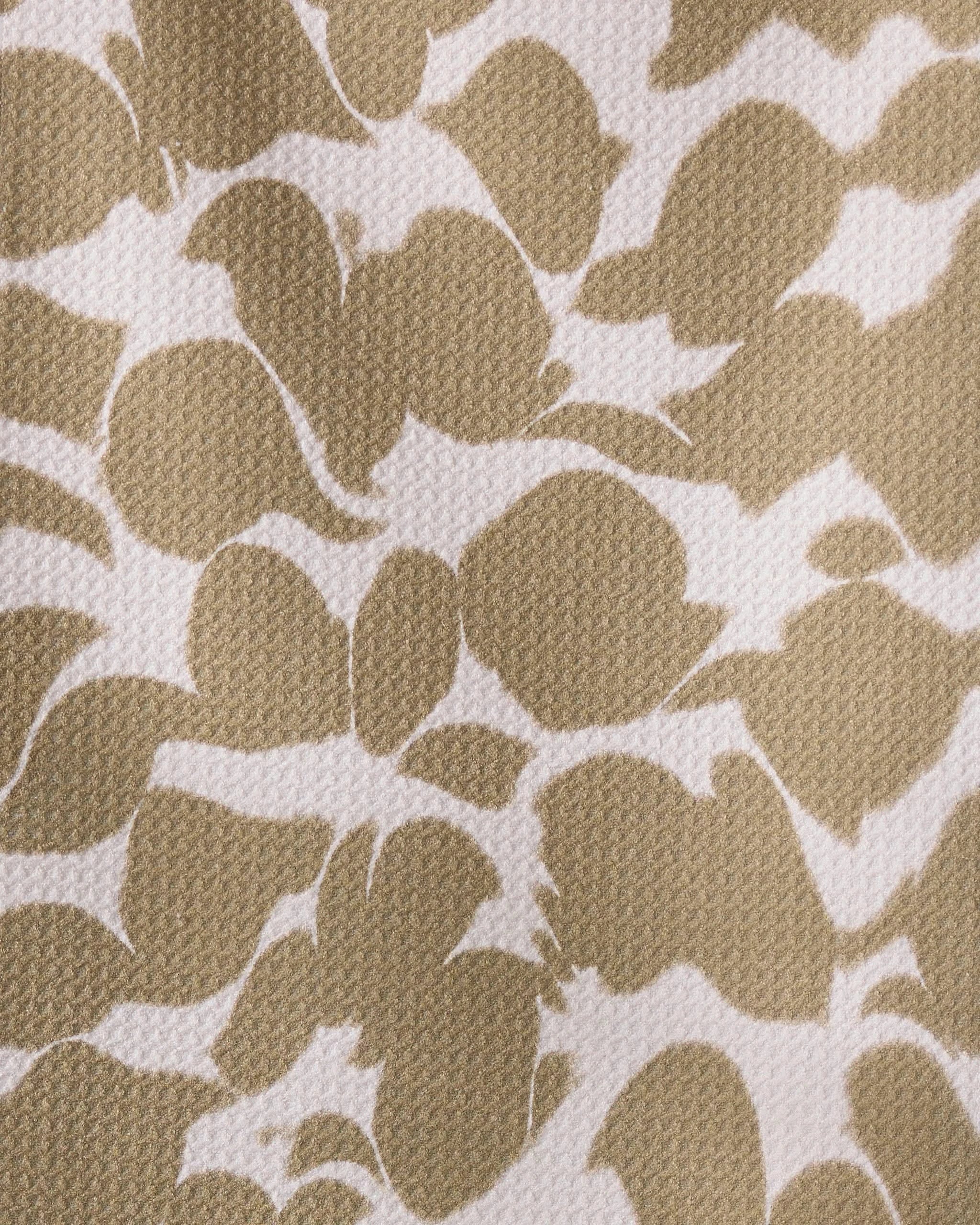 The Geometry Canopy bar towel features tan and white recycled fabric with an abstract leaf or petal pattern and a textured, ultra-absorbent surface of overlapping shapes in a natural arrangement.