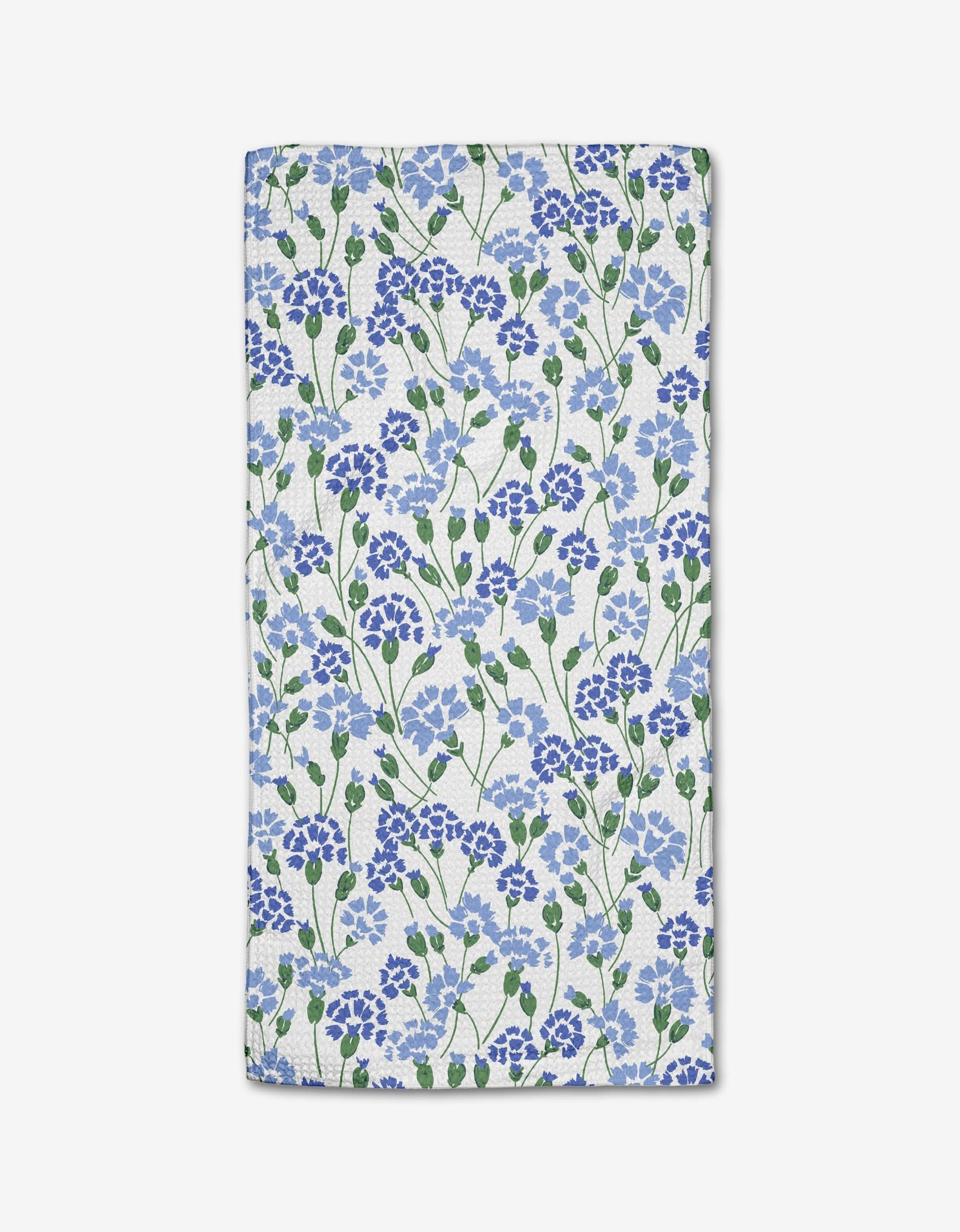 The Carnation Fields Bar Towel by Hufton Studio features a dense blue and purple floral pattern with green leaves on white Geoweave fabric.