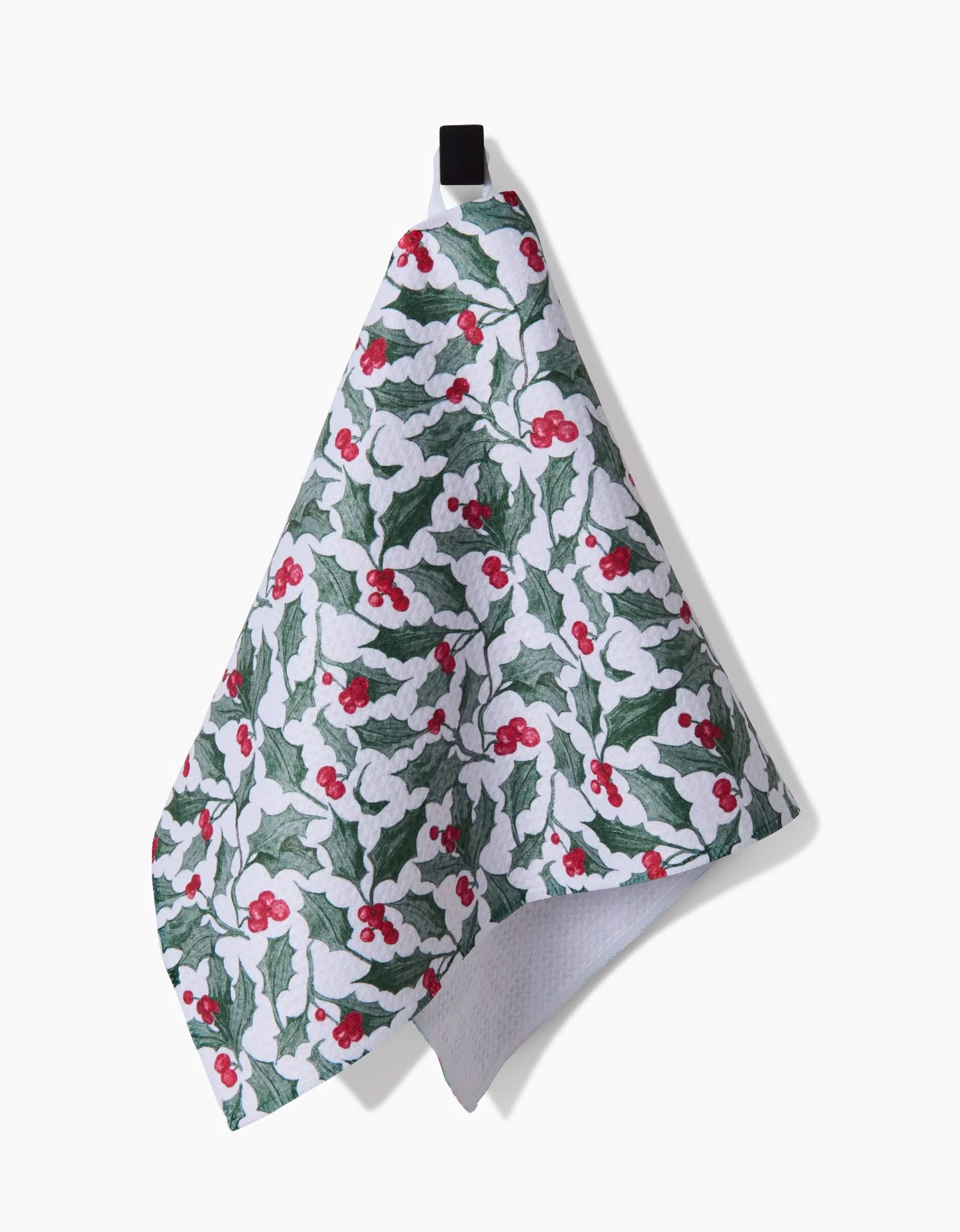 The Aubrey Fairchild Christmas Mistletoe towel is ultra-absorbent, featuring green holly leaves and red berries on white, with a black hanging loop—perfect for adding festive cheer to your kitchen.