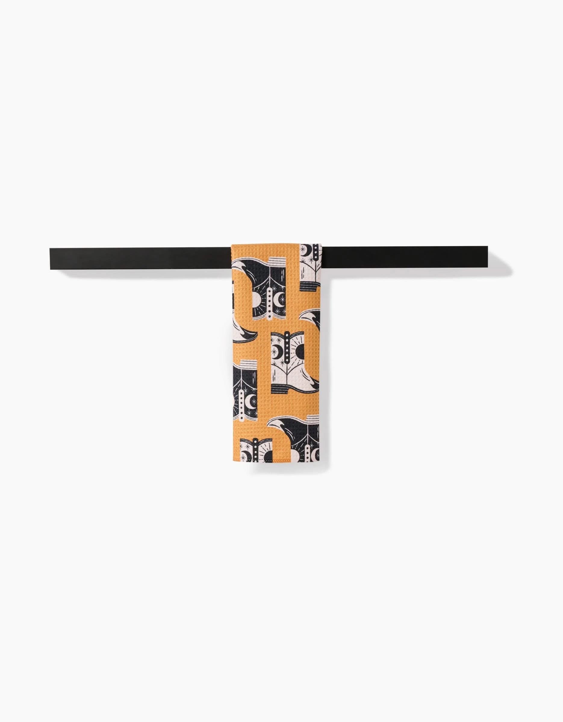 A pair of Megan Roy Cowboy Boots with an orange and black abstract pattern stands neatly against a plain white background.