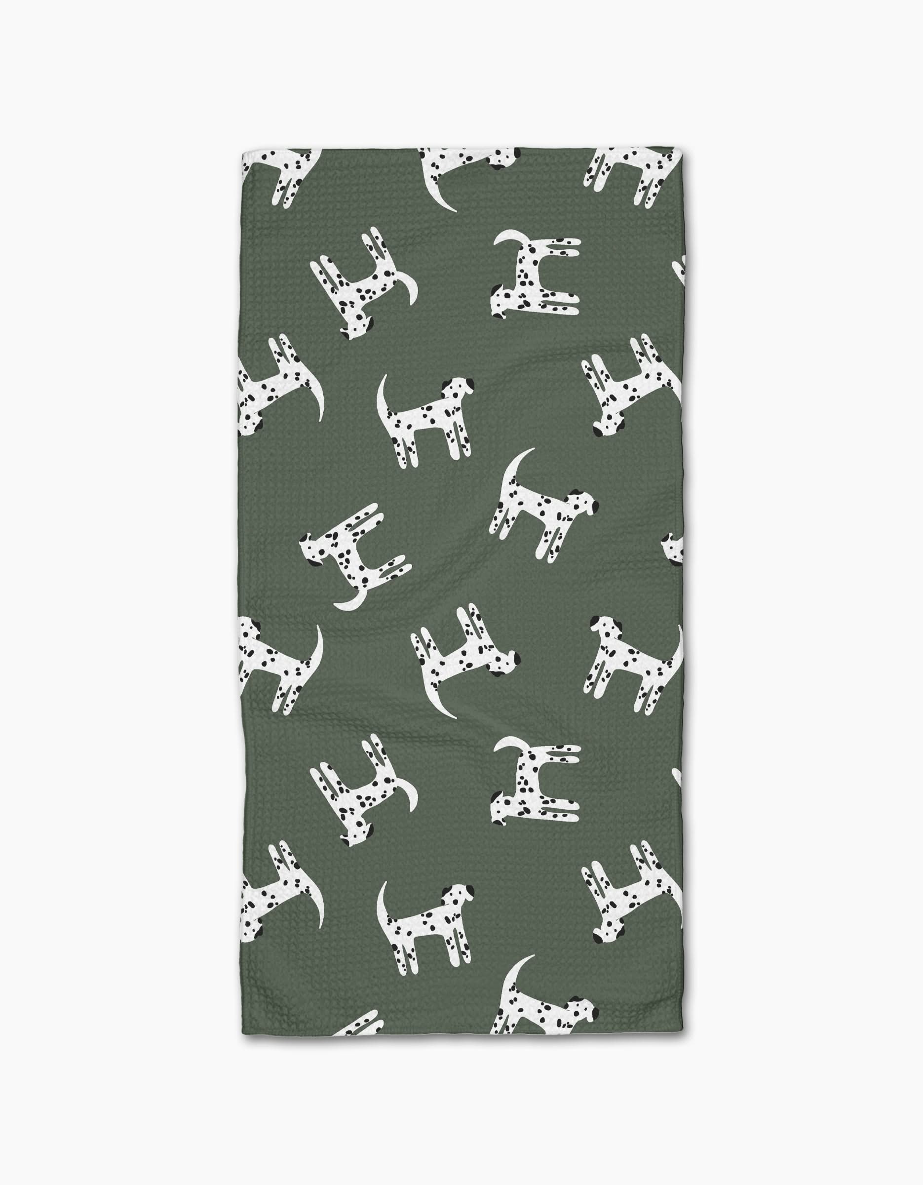 Coit Creatives Dalmatian Dogs is a green rectangular bar towel made from recycled materials, featuring a repeating pattern of white Dalmatian dogs with black spots in varied orientations.