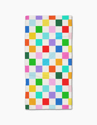 The Dance Floor quilt by Vaishali Design Studio is made from recycled materials and showcases a grid of colorful squares separated by white, all laid flat on a white background.