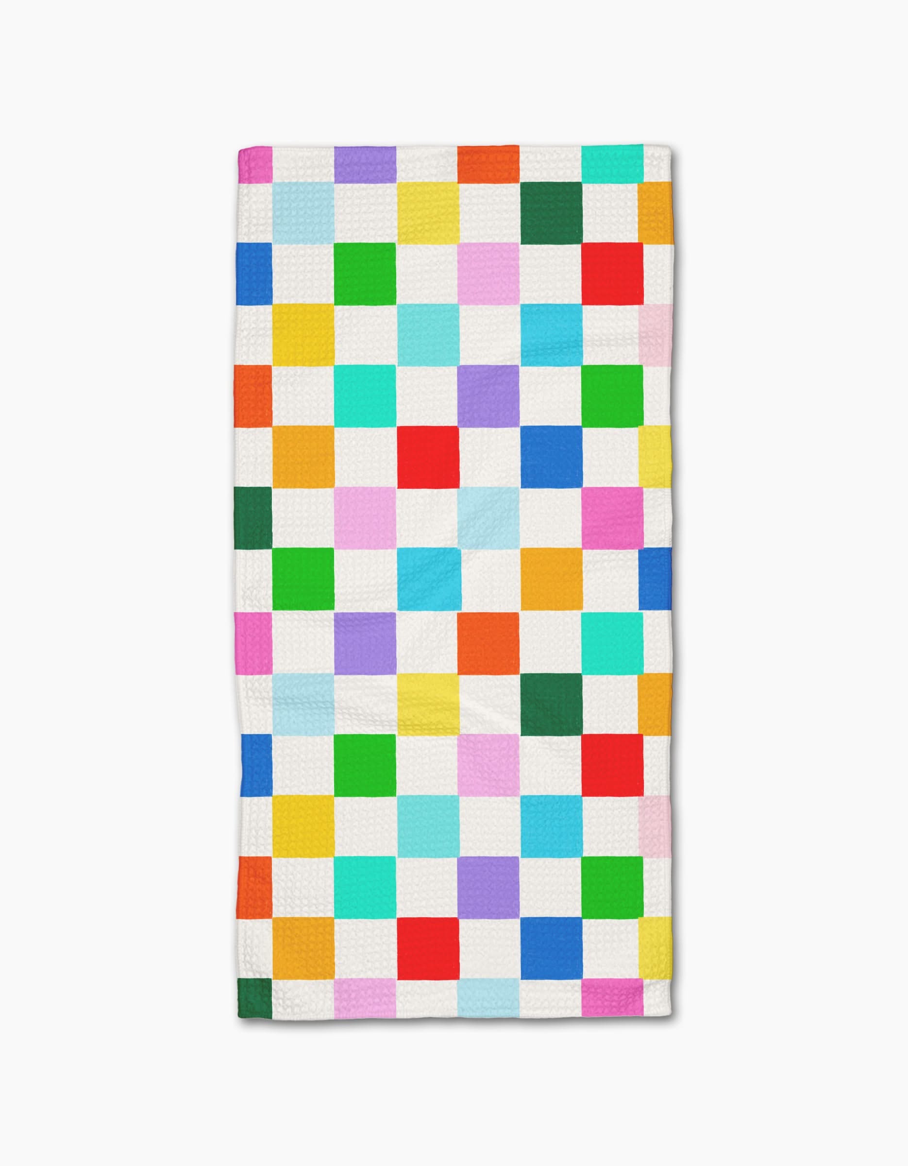 The Dance Floor quilt by Vaishali Design Studio is made from recycled materials and showcases a grid of colorful squares separated by white, all laid flat on a white background.