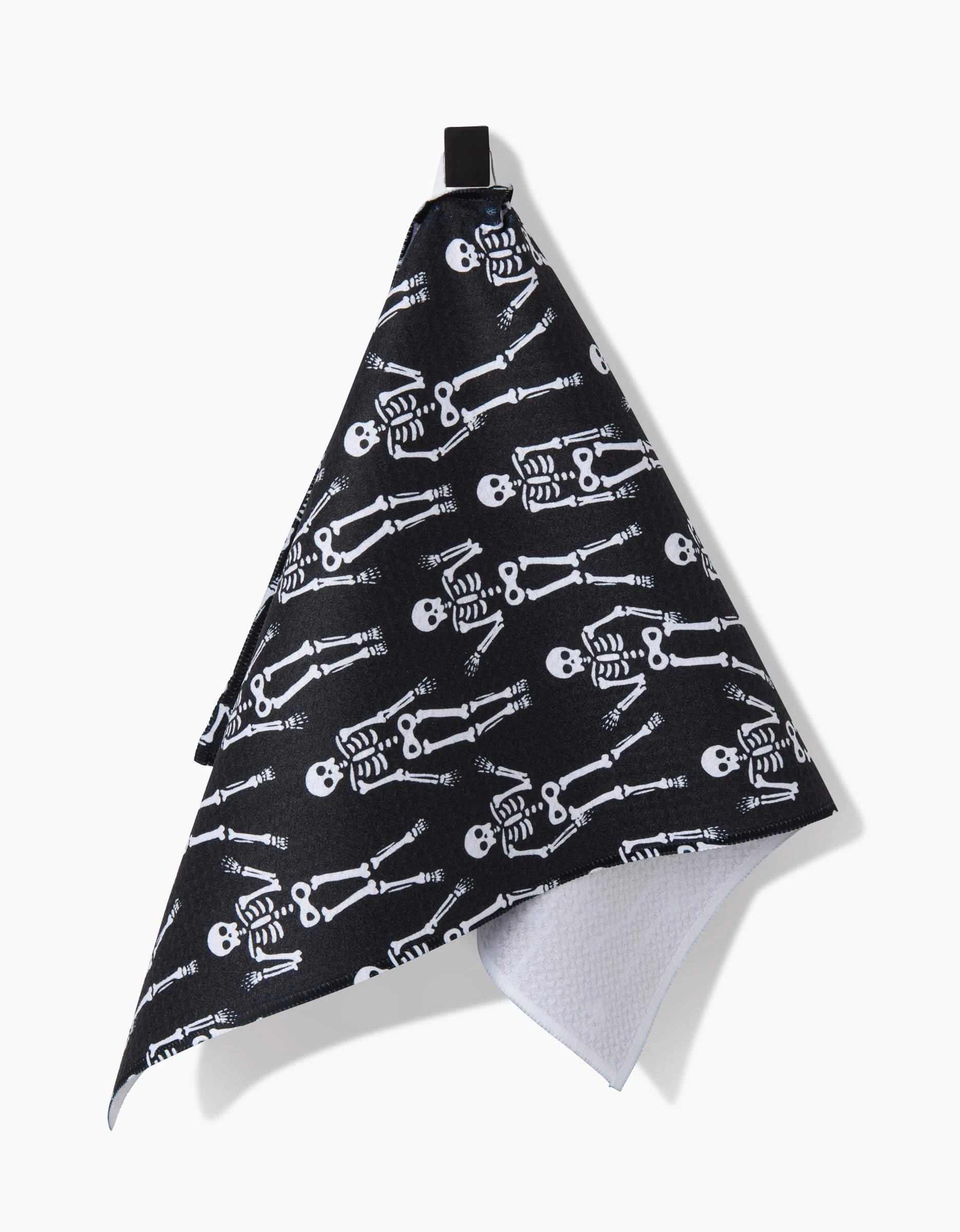 The Dancing Skeletons Black White towel by Hufton Studio features a black side with white skeletons, a white recycled-material reverse, and a unique triangular shape—perfect as an eye-catching and eco-friendly bar towel.