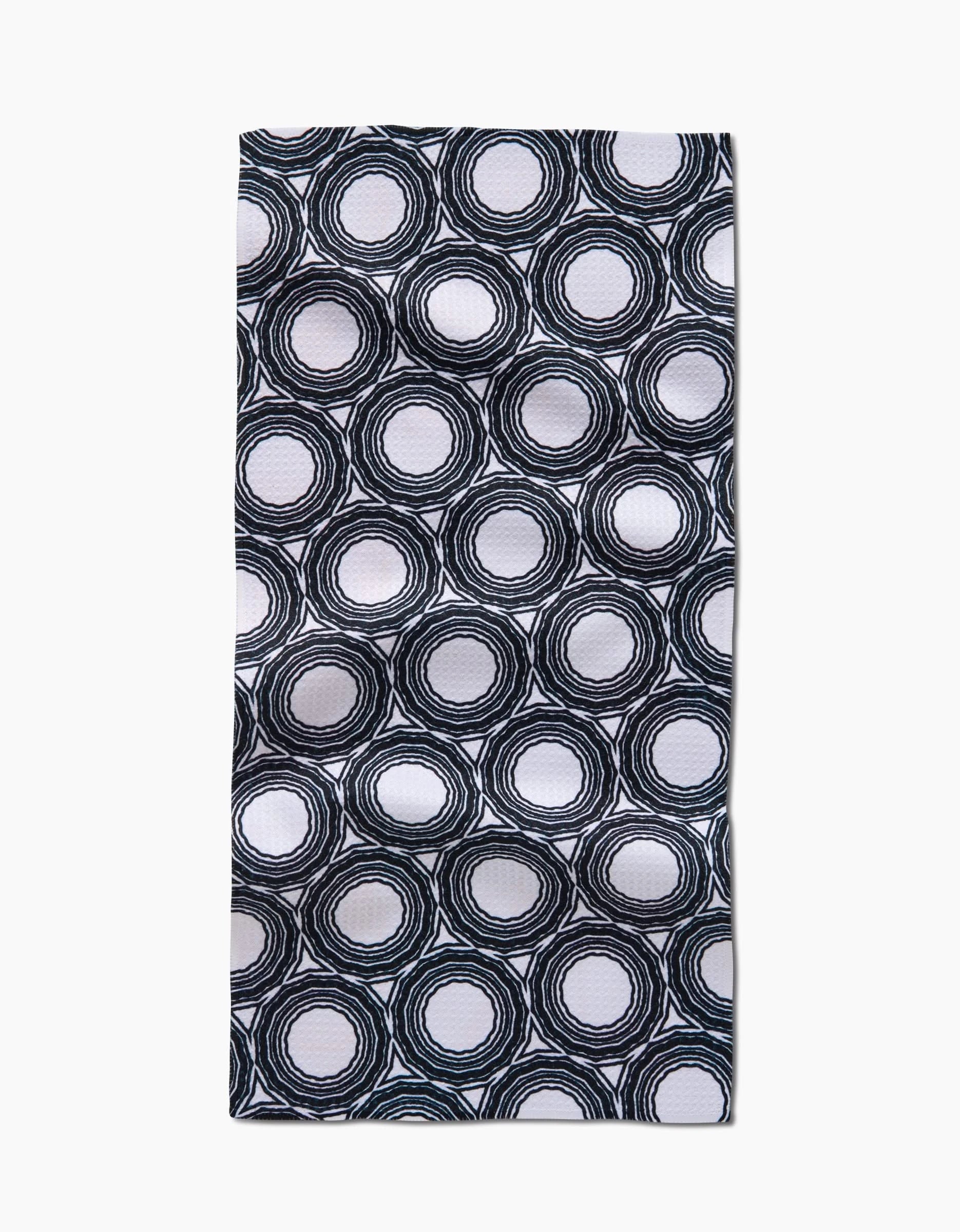 The Dosido Bar Towel by Katherine Berkeley features black and white hand-drawn concentric circles on a white background, made from ultra-absorbent Geoweave fabric.