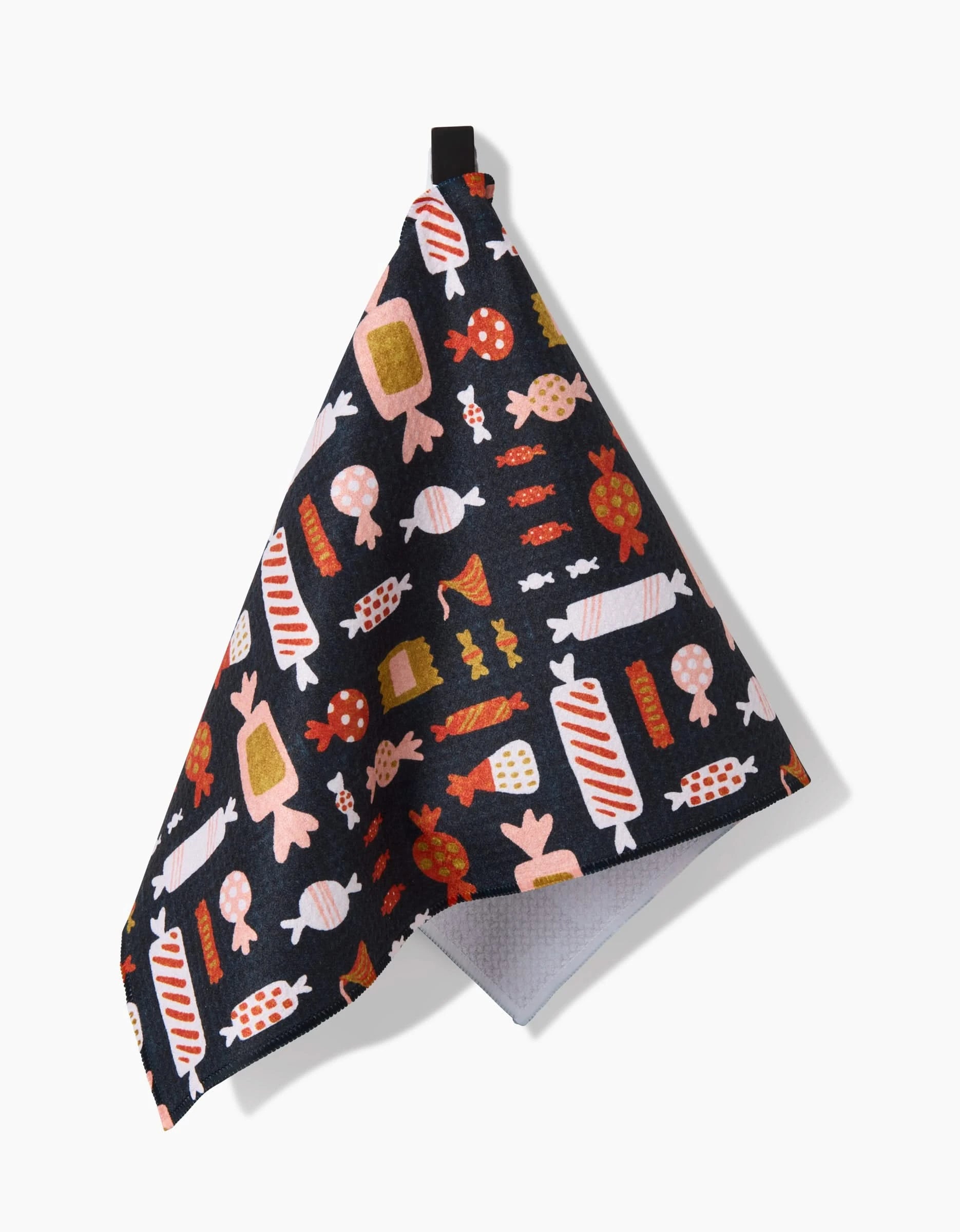 The Amy MacCready Edwina towel, ultra-absorbent and dark-colored, features a playful colorful candy pattern and hangs by a black loop against a white background.