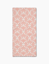 The Ethereal Seaweeds in Blush by Jasmine Blooms Designs is a rectangular white cloth with coral pink, symmetrical seaweed motifs made from recycled materials for a classic, elegant look. Shown flat against a white background.