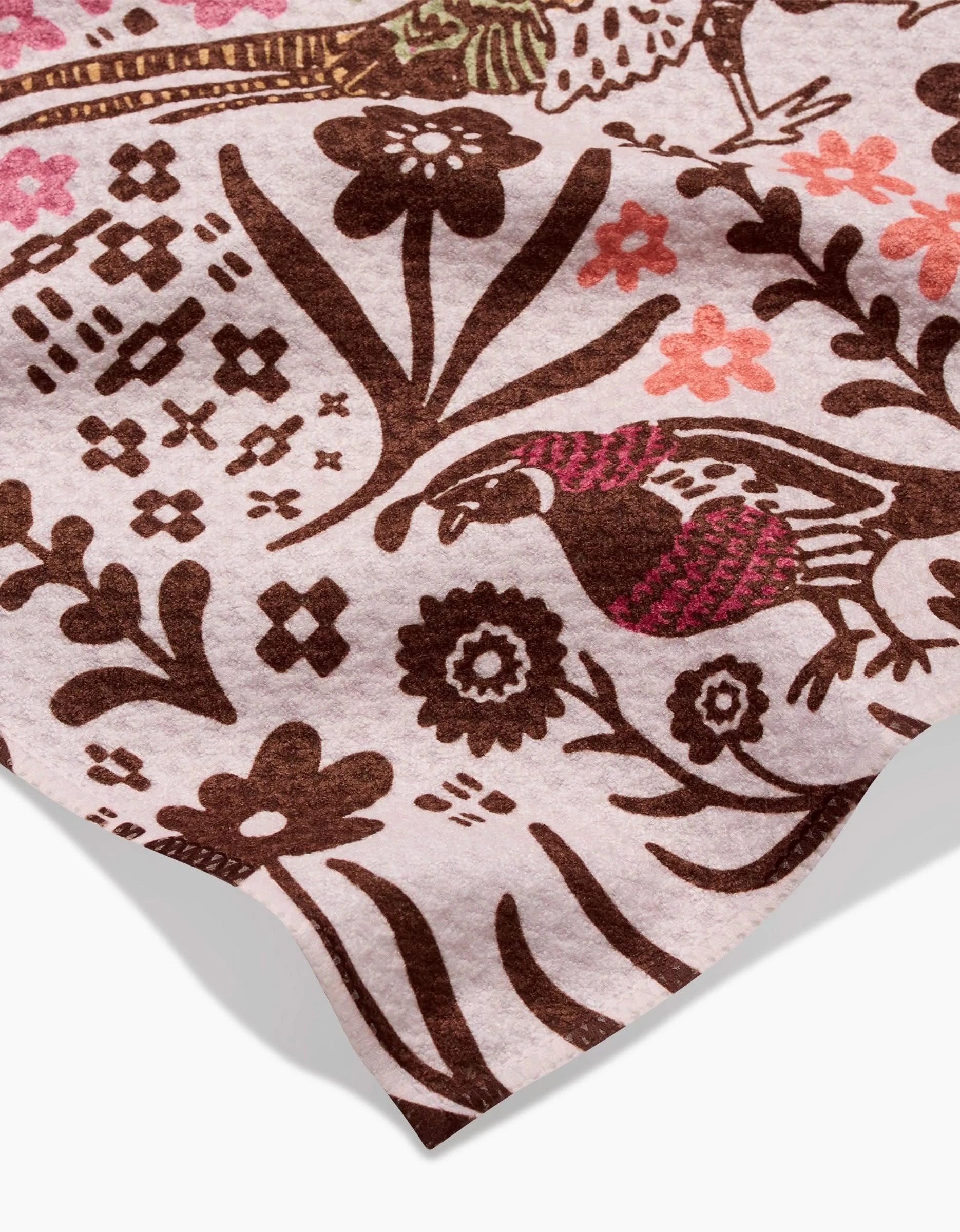 A close-up of the Kayla Ann Fall Fowl bar towel, made from recycled materials, showcasing a folk art-style floral and bird pattern in brown and pink on a light background.