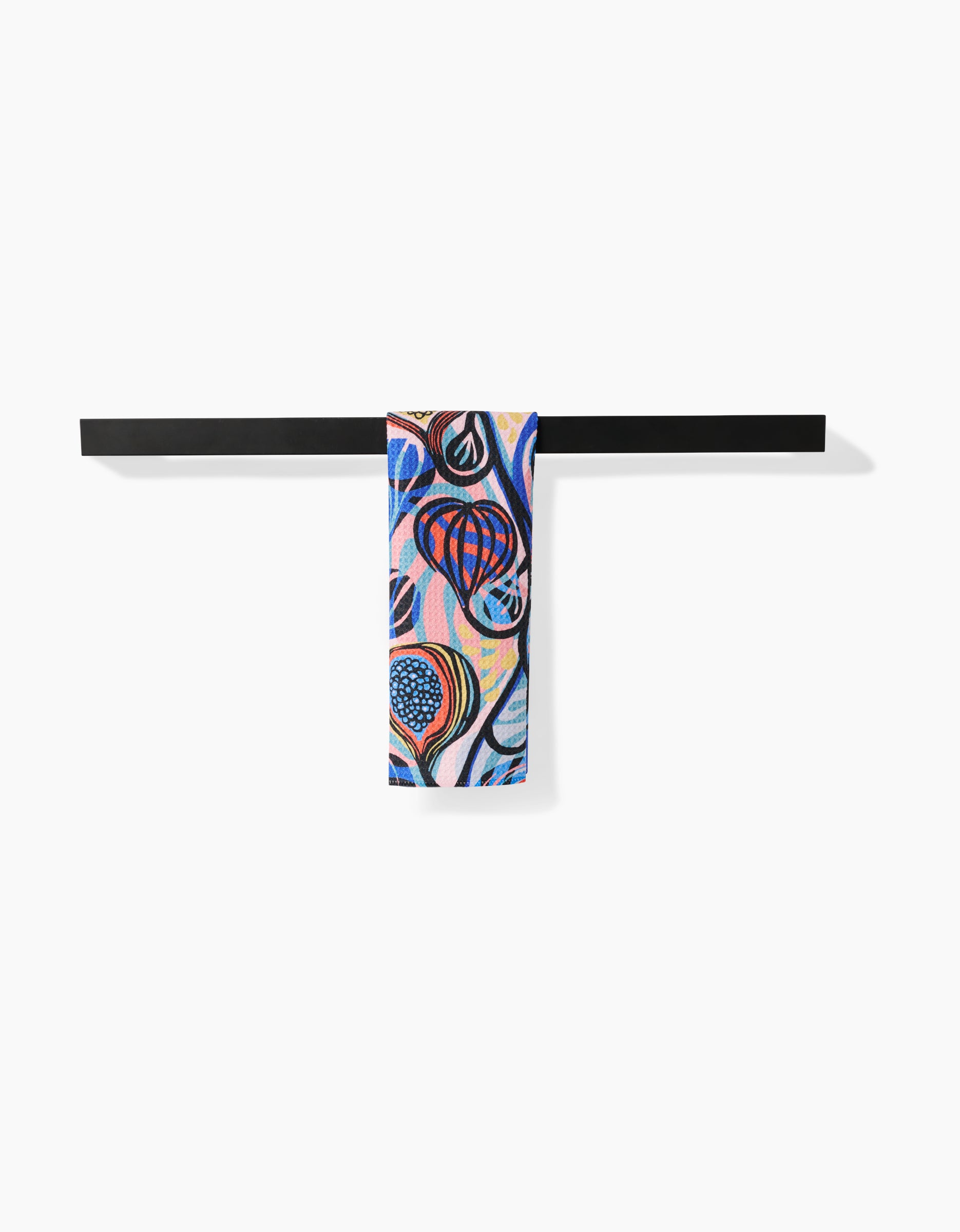The Fig Garden Bar Towel by Masha Volnova, crafted from Geoweave fabric, showcases vibrant abstract blue, red, and black patterns and hangs elegantly over a sleek black bar against a white background.