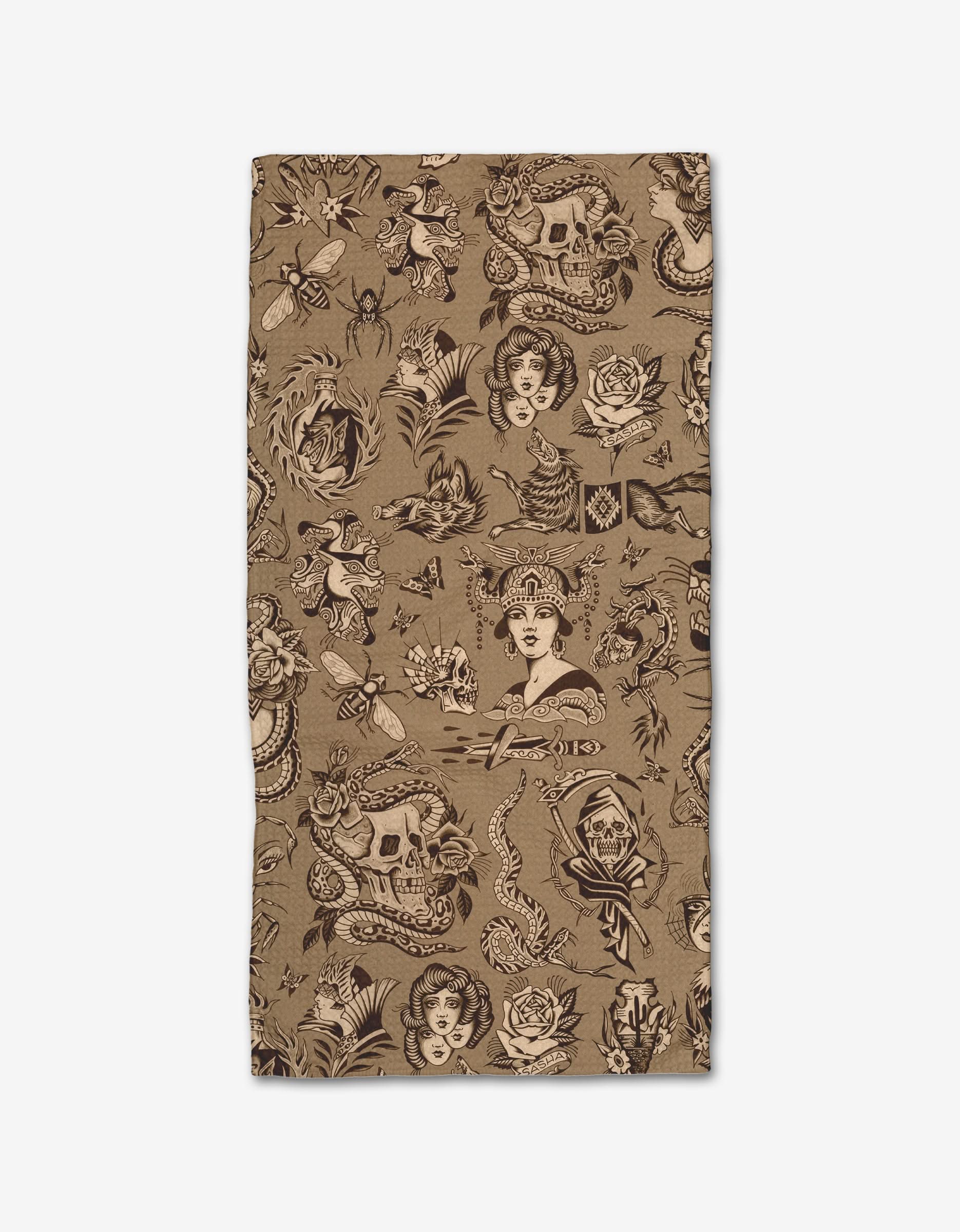 Flash by Cole Strem is a rectangular Bar Towel made from Geoweave fabric, featuring a vintage-style all-over black tattoo print of skulls, snakes, roses, women’s faces, and other classic motifs.