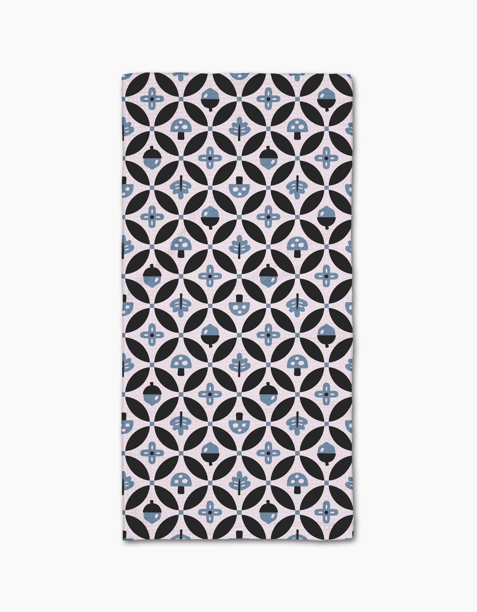 The Forest Findings rectangular bar towel by Anette Heiberg showcases black and light blue geometric shapes on white Geoweave fabric, blending circles, diamonds, and abstract floral motifs in a stylish pattern.