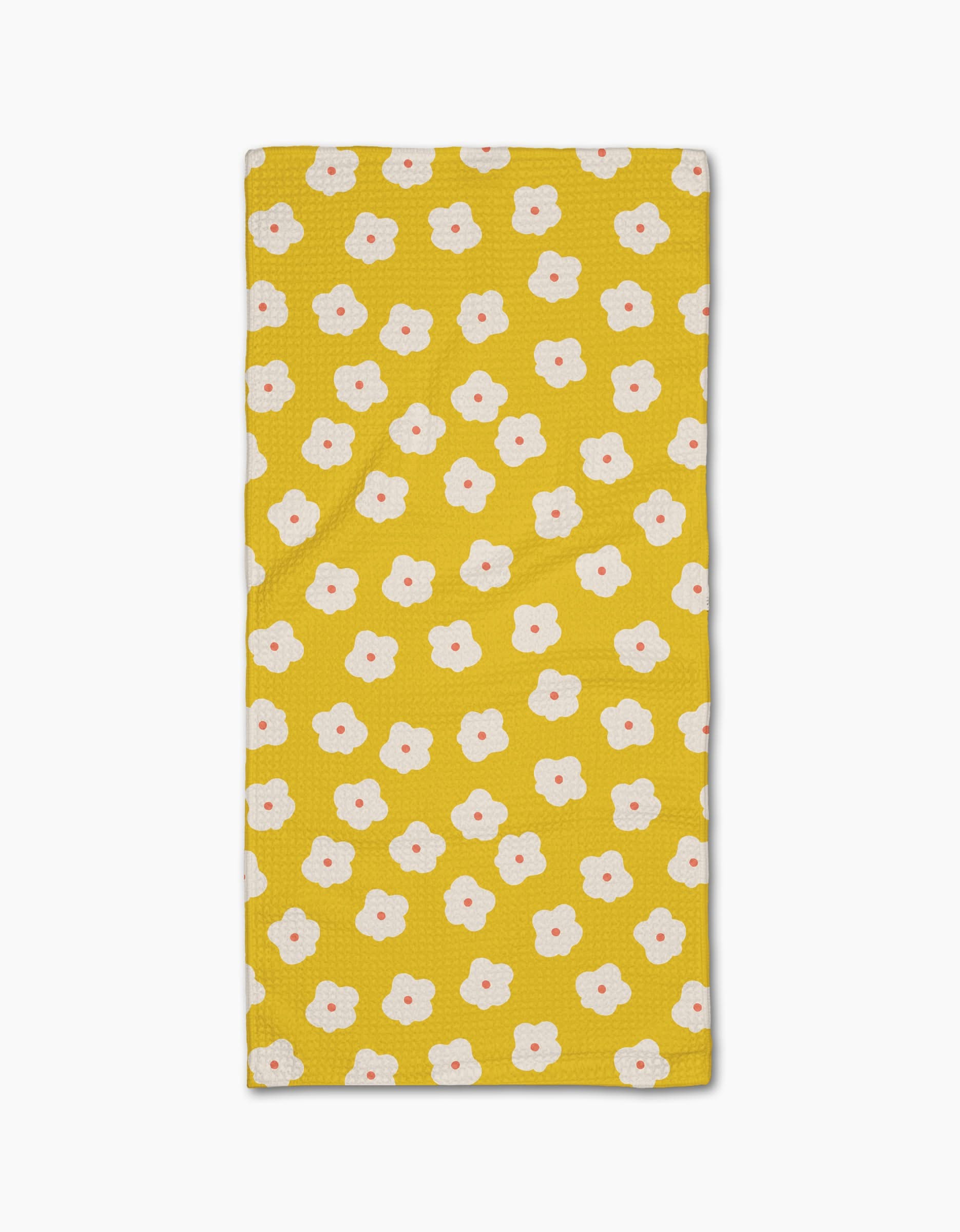 The Sara Mari Garden Crush Bar Towel is yellow and rectangular, featuring a Geoweave fabric with small white flowers with orange centers evenly spaced across the surface.