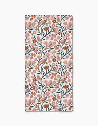 The Golden Hour Park Lane bar towel by Charlie Rowan Designs features a rectangular shape with a repeating pattern of pink, orange, and brown flowers, green stems and leaves, birds, and berries on white Geoweave fabric made from recycled materials.