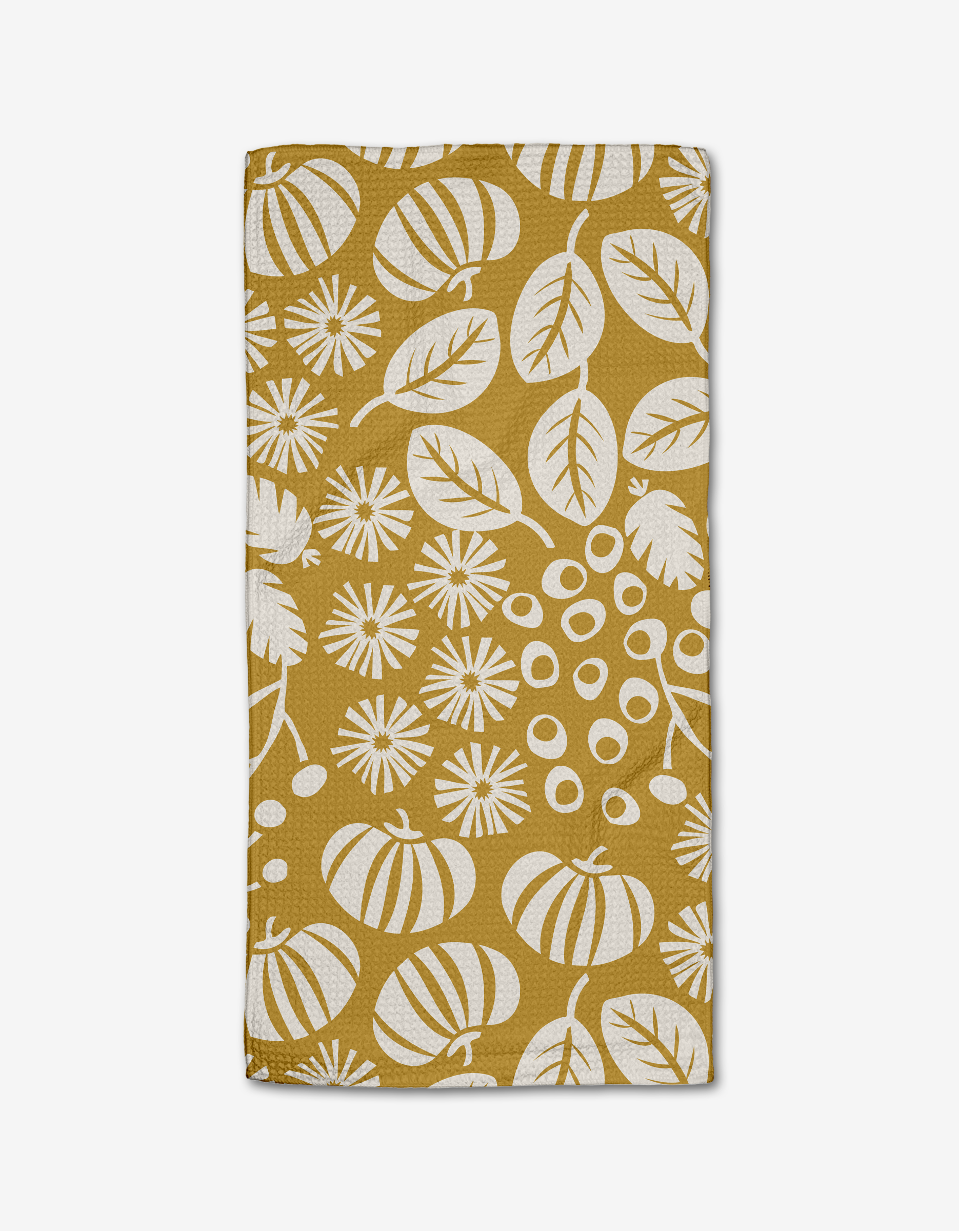 The Lizzie Clark Harvest Toss bar towel features a mustard yellow rectangular design with a white botanical pattern of leaves, flowers, and abstract shapes. Made from soft Geoweave fabric for outstanding absorbency; shown folded on a white background.