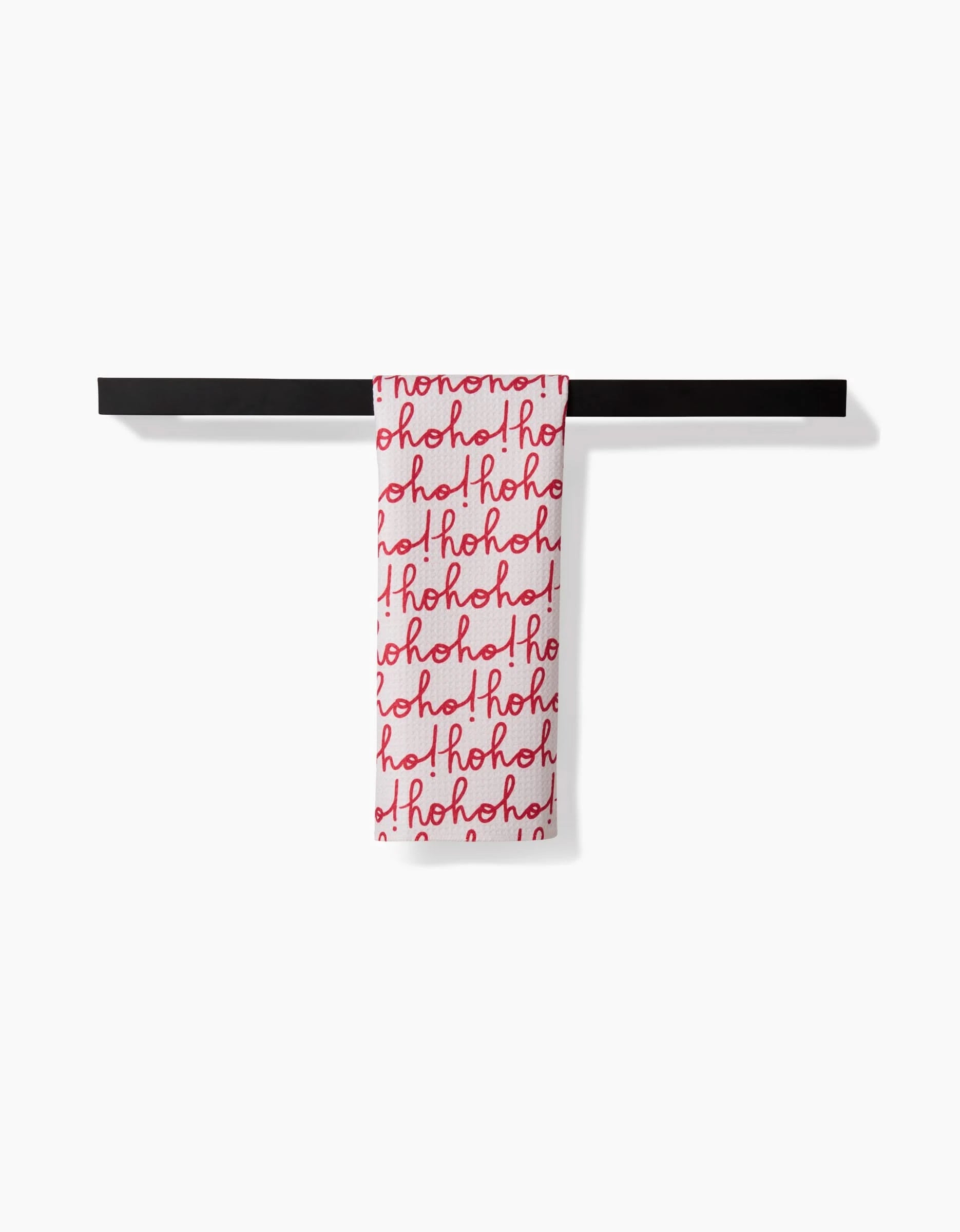 The Kayla Ann Ho Ho Holiday Red towel is ultra-absorbent, white, and features red handwritten ho! ho! ho! text, displayed on a black horizontal towel bar against a plain white background.