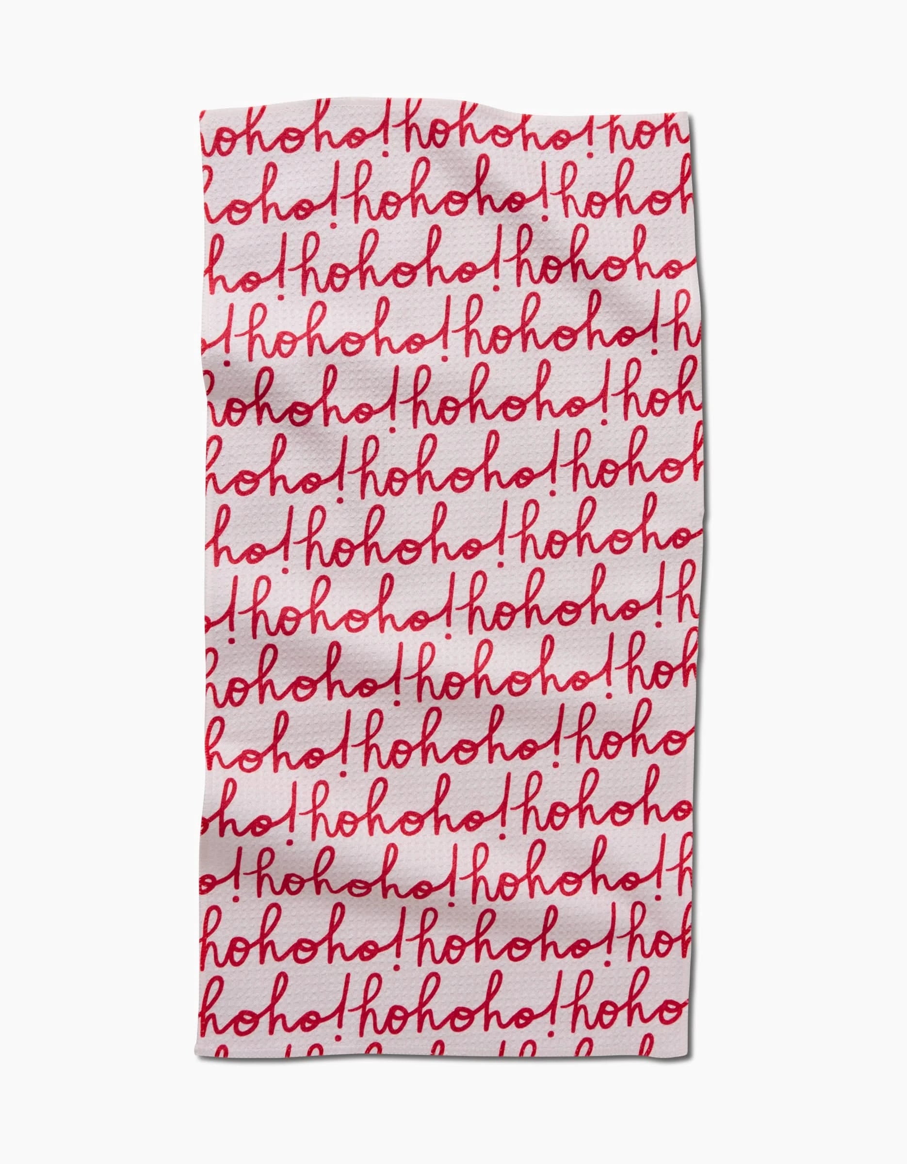 The Kayla Ann Ho Ho Holiday Red bar towel, made from recycled Geoweave fabric, features repeated “ho ho ho!” in red cursive on white for a festive Christmas look. Visible folds and creases add to its textured charm.